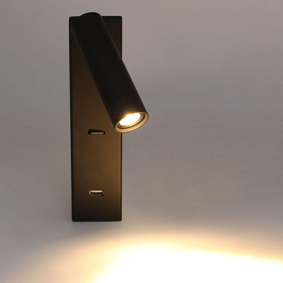 Black Uno head casting light beside its wall plate