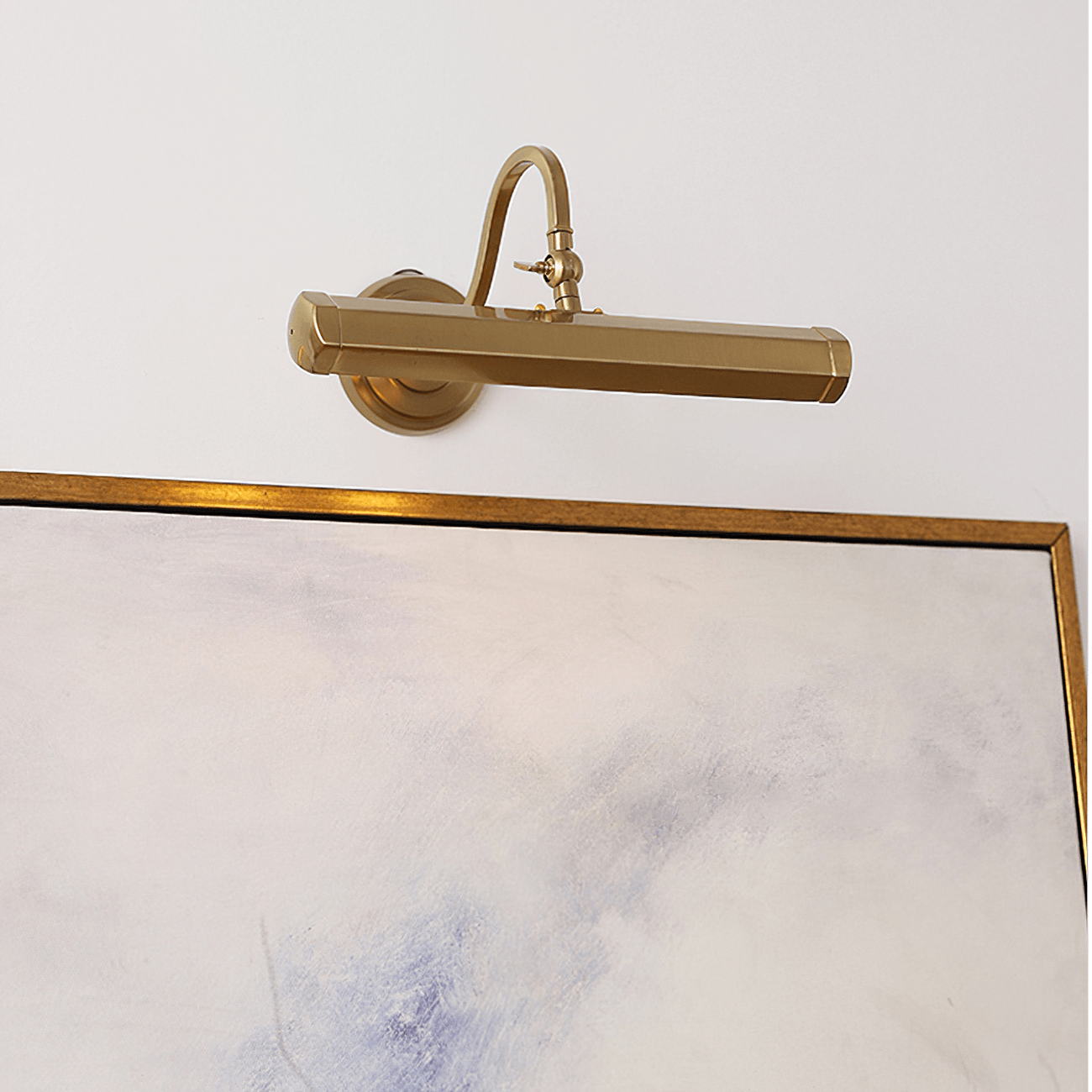 Gold picture light above a framed print