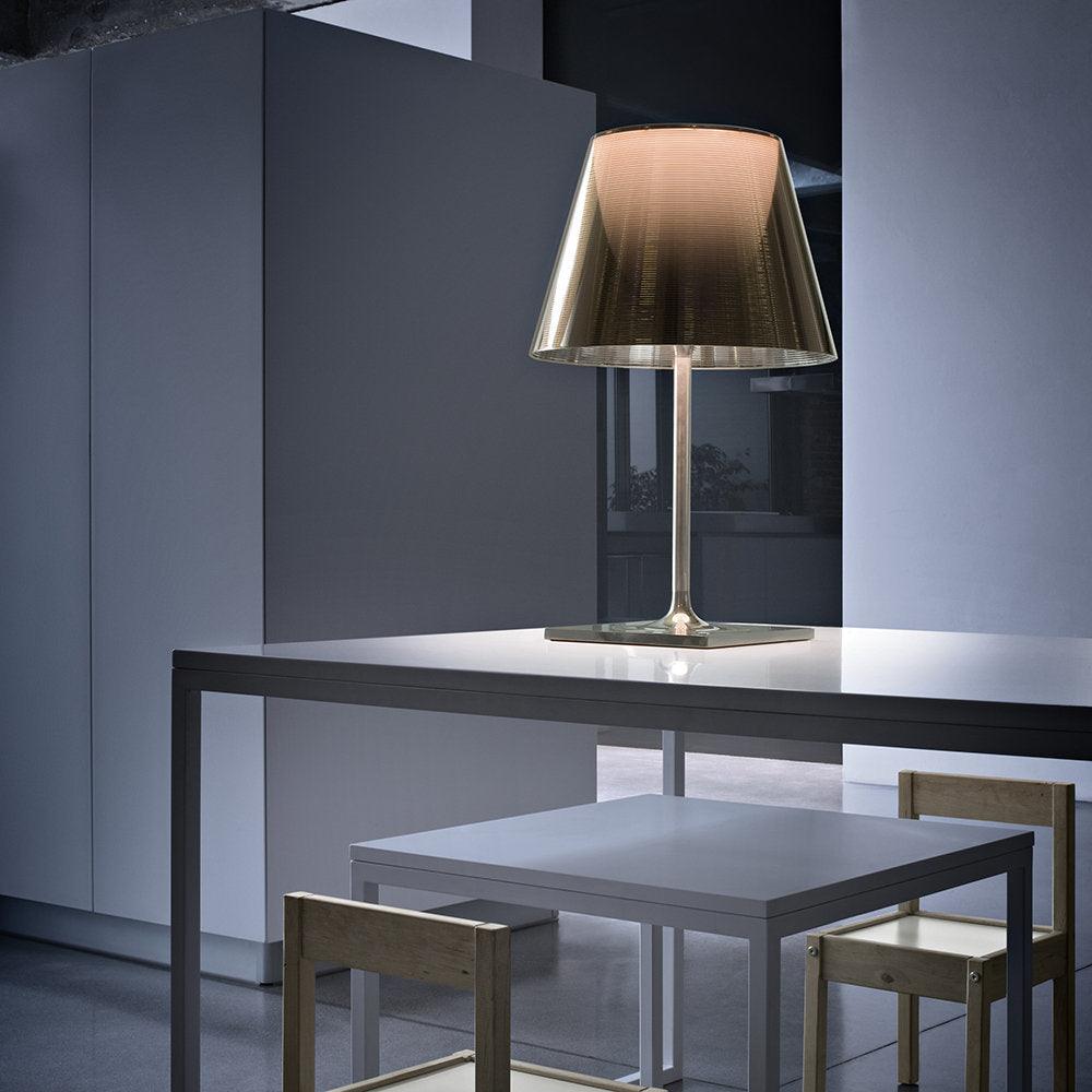 Reflective Chrome Prism lamp on a dark dining console