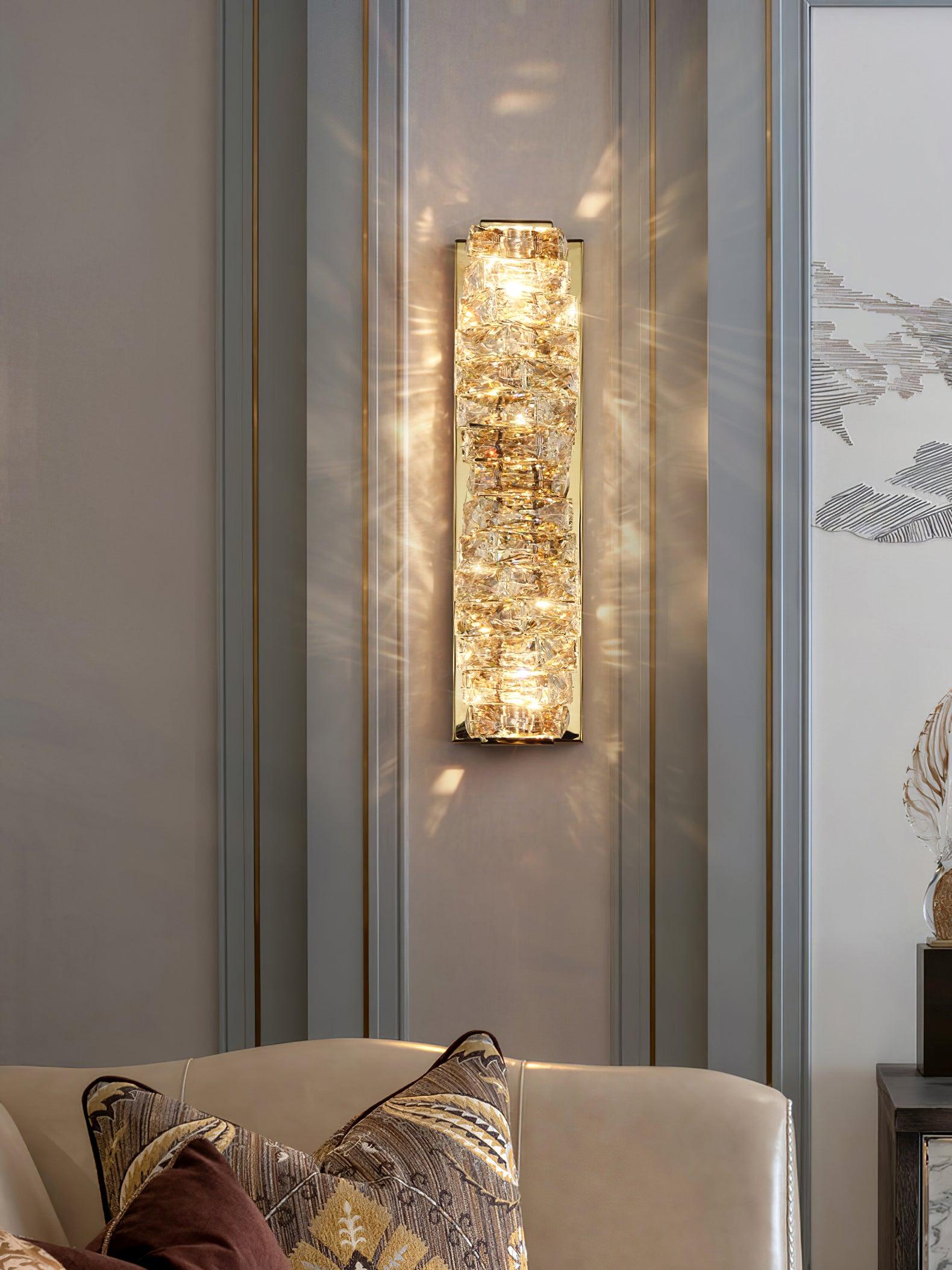 Gold crystal sconce above a sofa