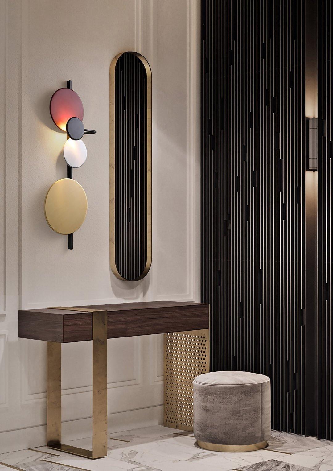 Disc wall lamp beside a hallway mirror