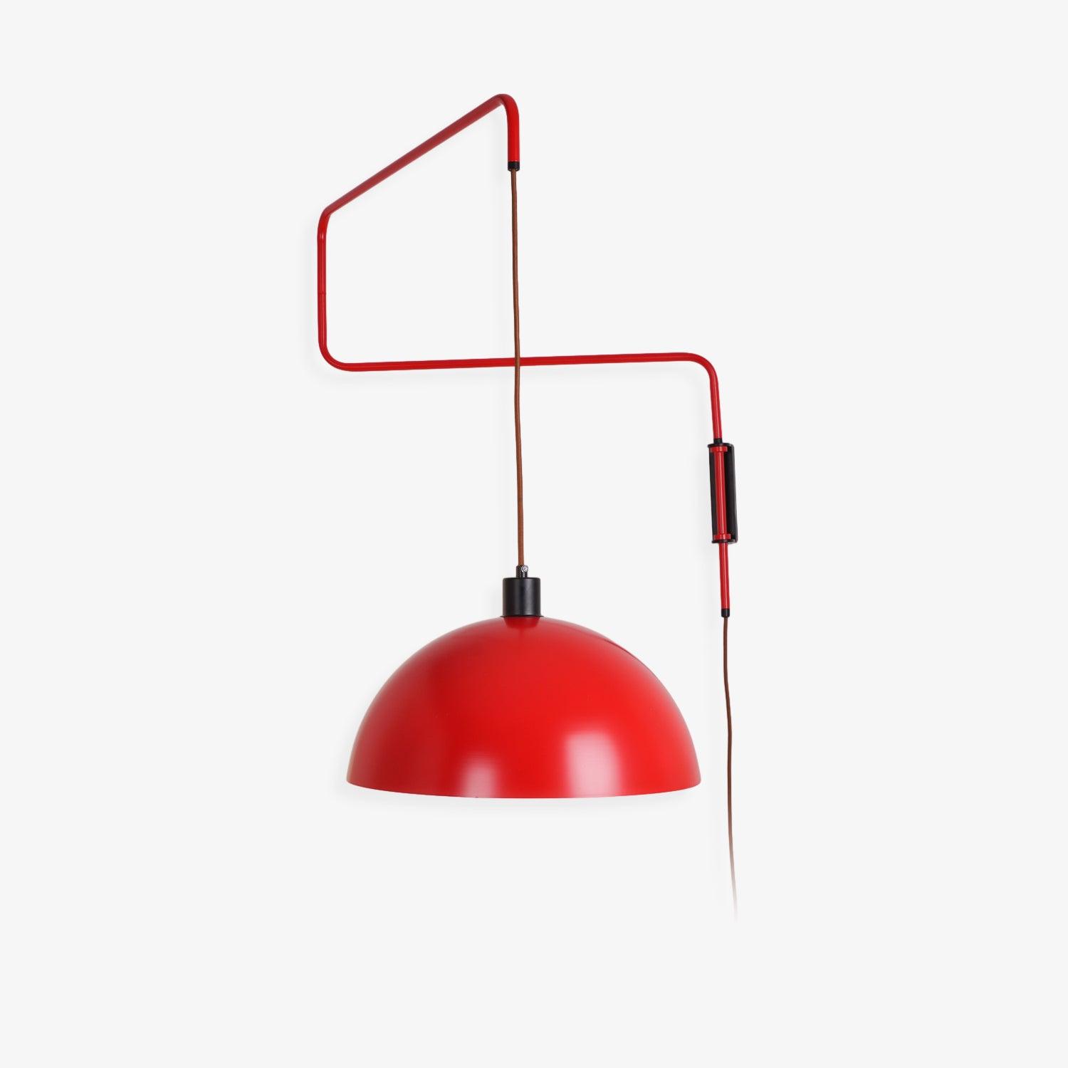 Red dome and bent arm against a plain wall