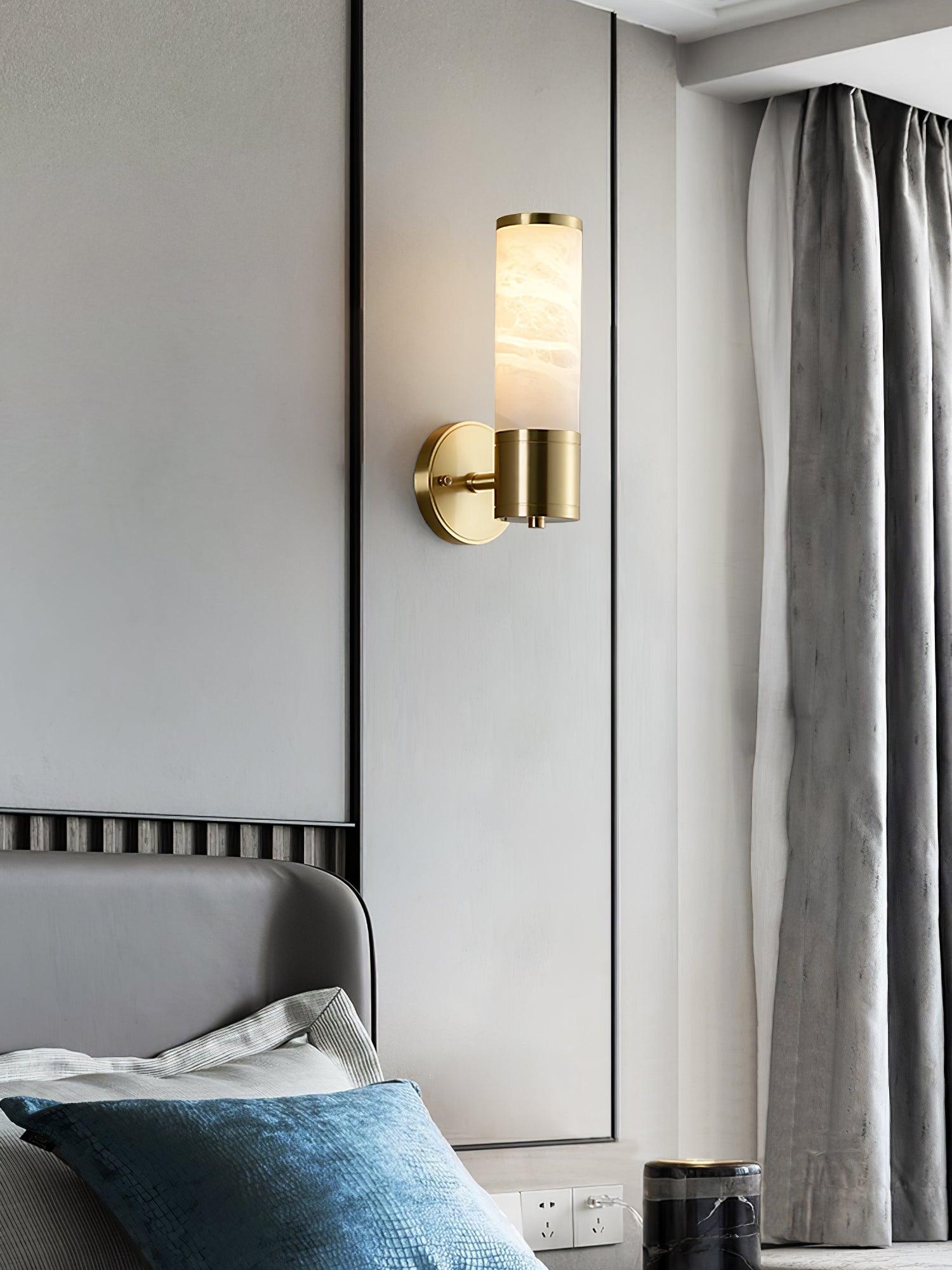 Short stone tube above a gold-coloured collar in a bedroom