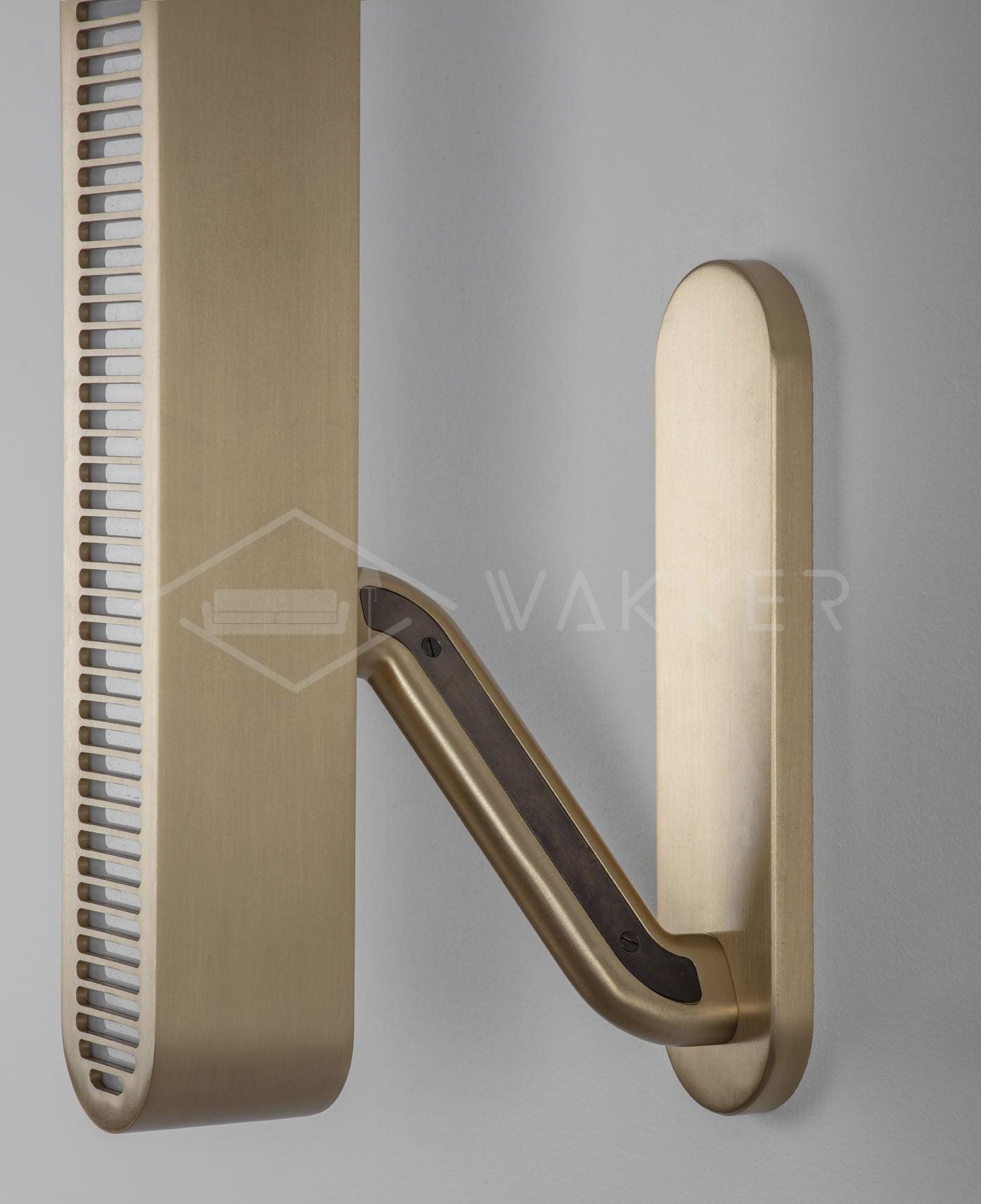 Angled view of a brass bar and bent support arm