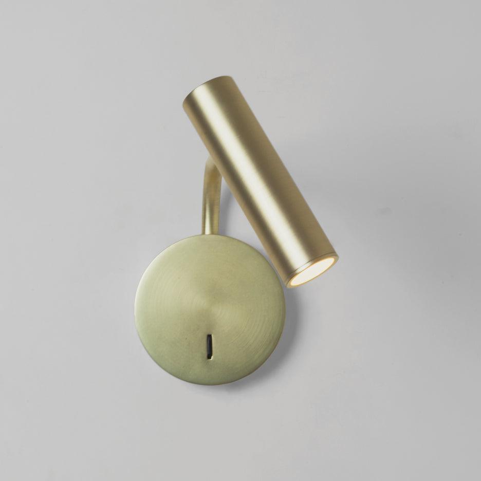 Gold-coloured circular plate with angled cylinder