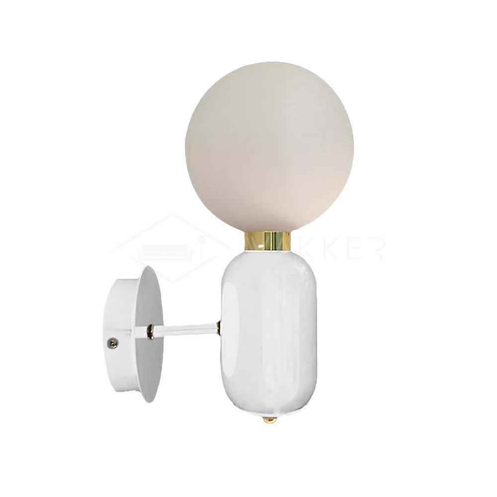 White Aballs wall light on white, globe above rounded body, short projecting arm, circular plate and gold-tone collar