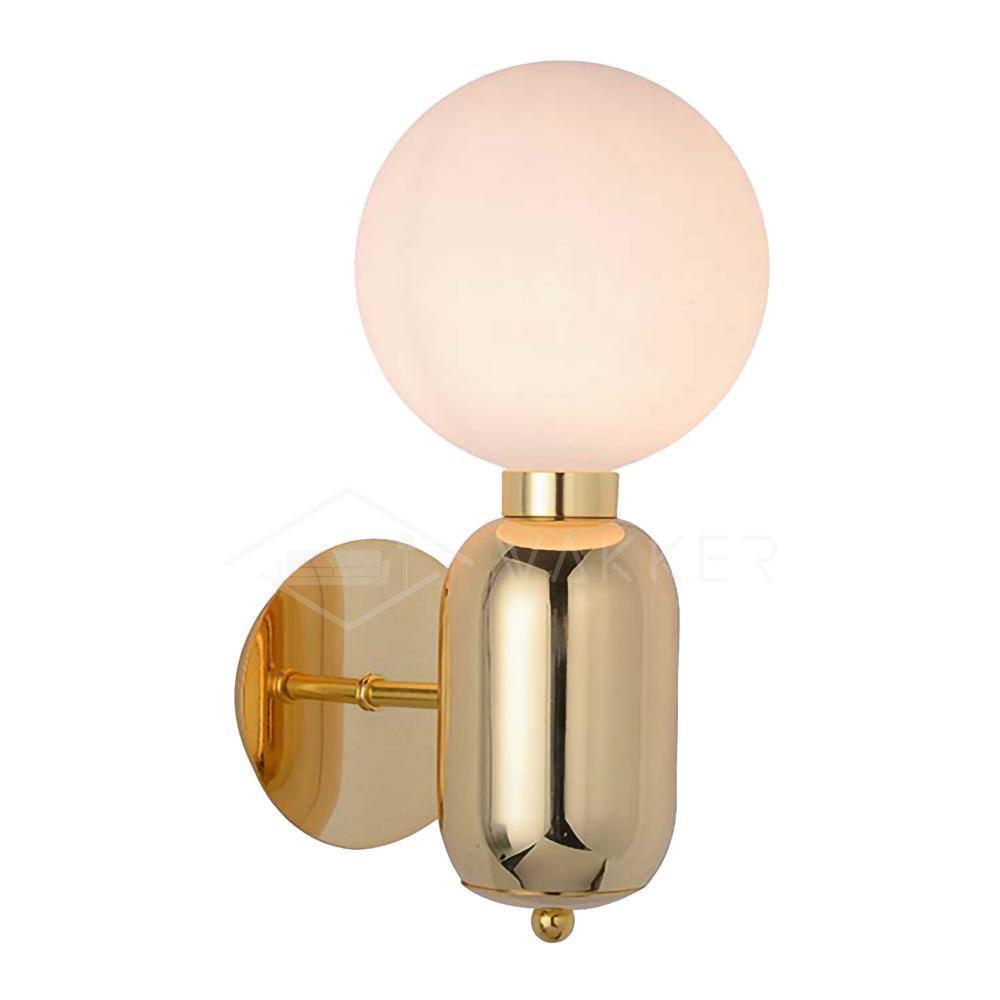 Gold-toned Aballs wall sconce isolated on white, glowing globe, reflective body, short arm and round plate