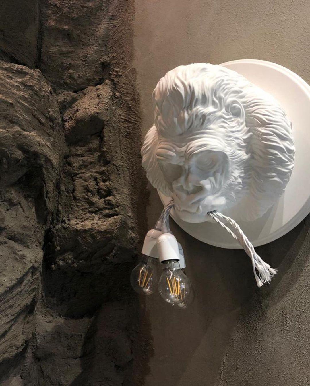 Close-up of white sculpture against dark stone