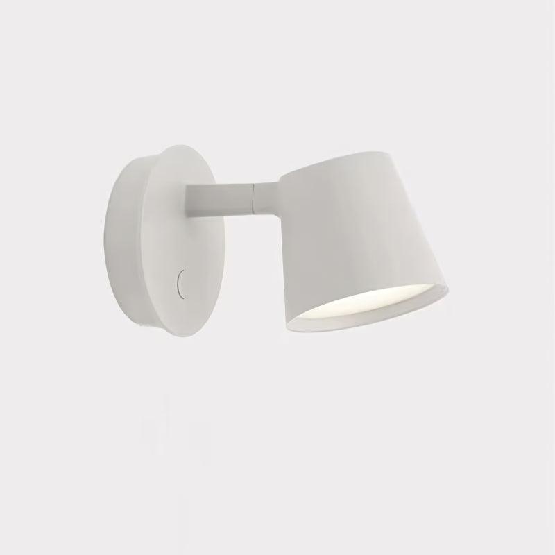 White Tip fixture on pale square background, with round plate at left and tapered head pointing down to right
