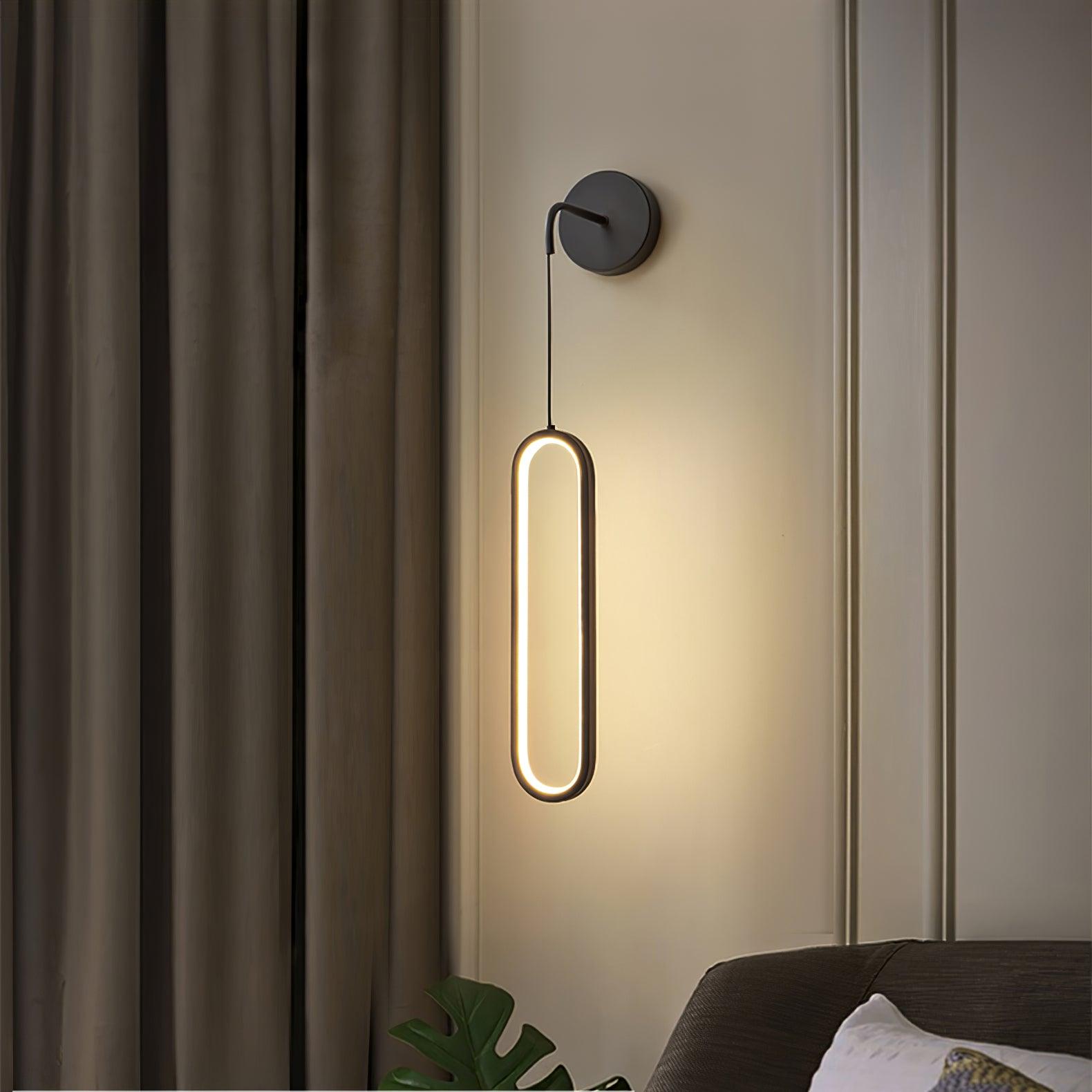 Black-option oval wall light beside curtains