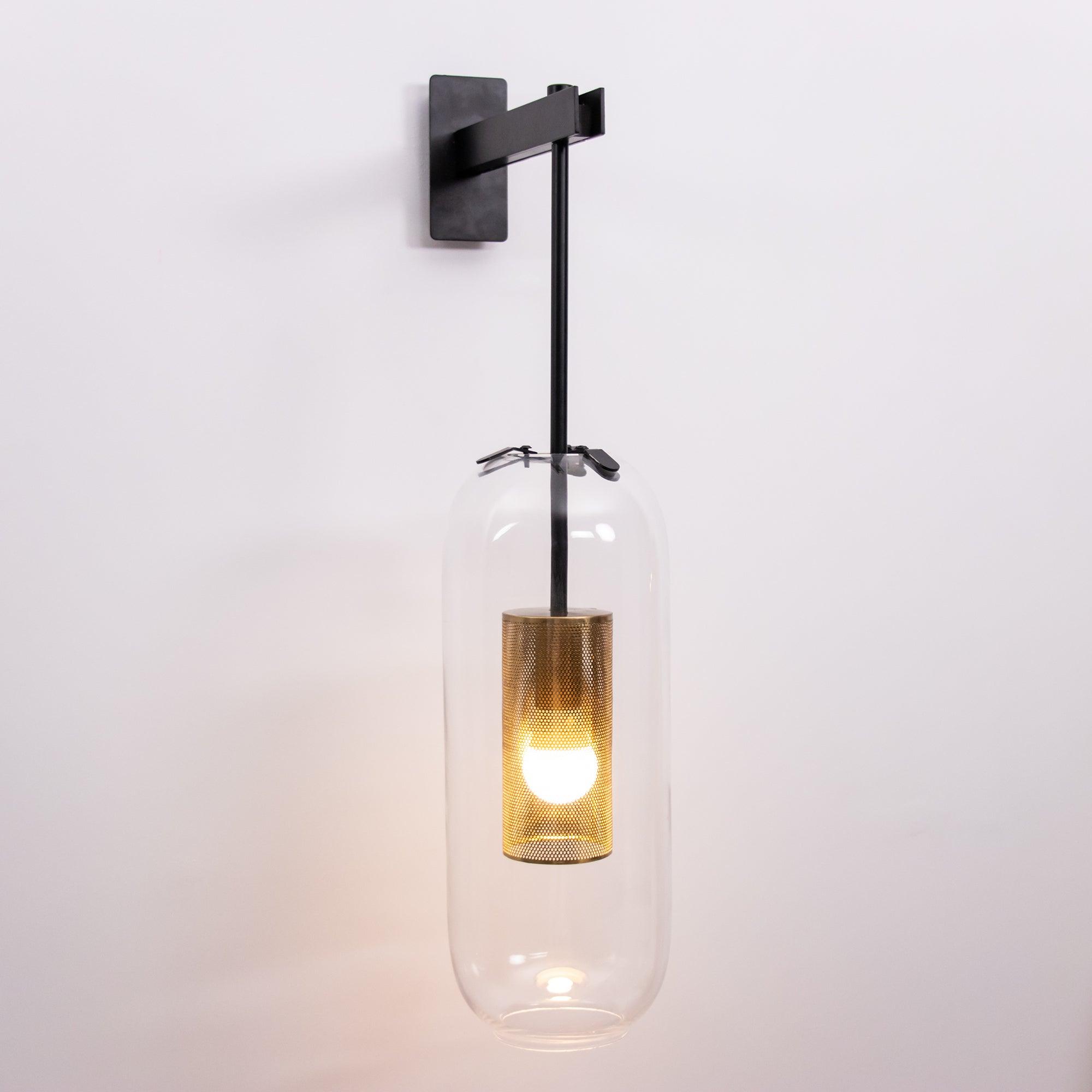 Black wall light with suspended glowing glass