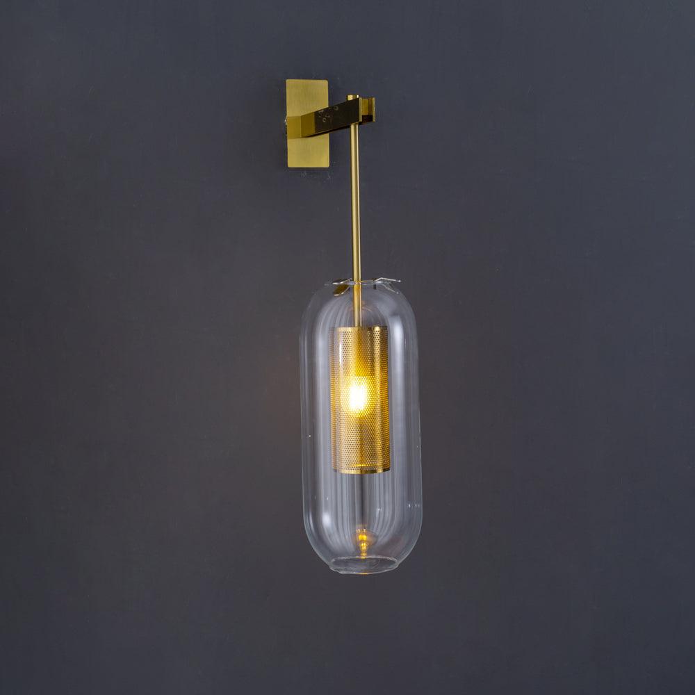 Gold-coloured fixture and clear glass on a dark wall