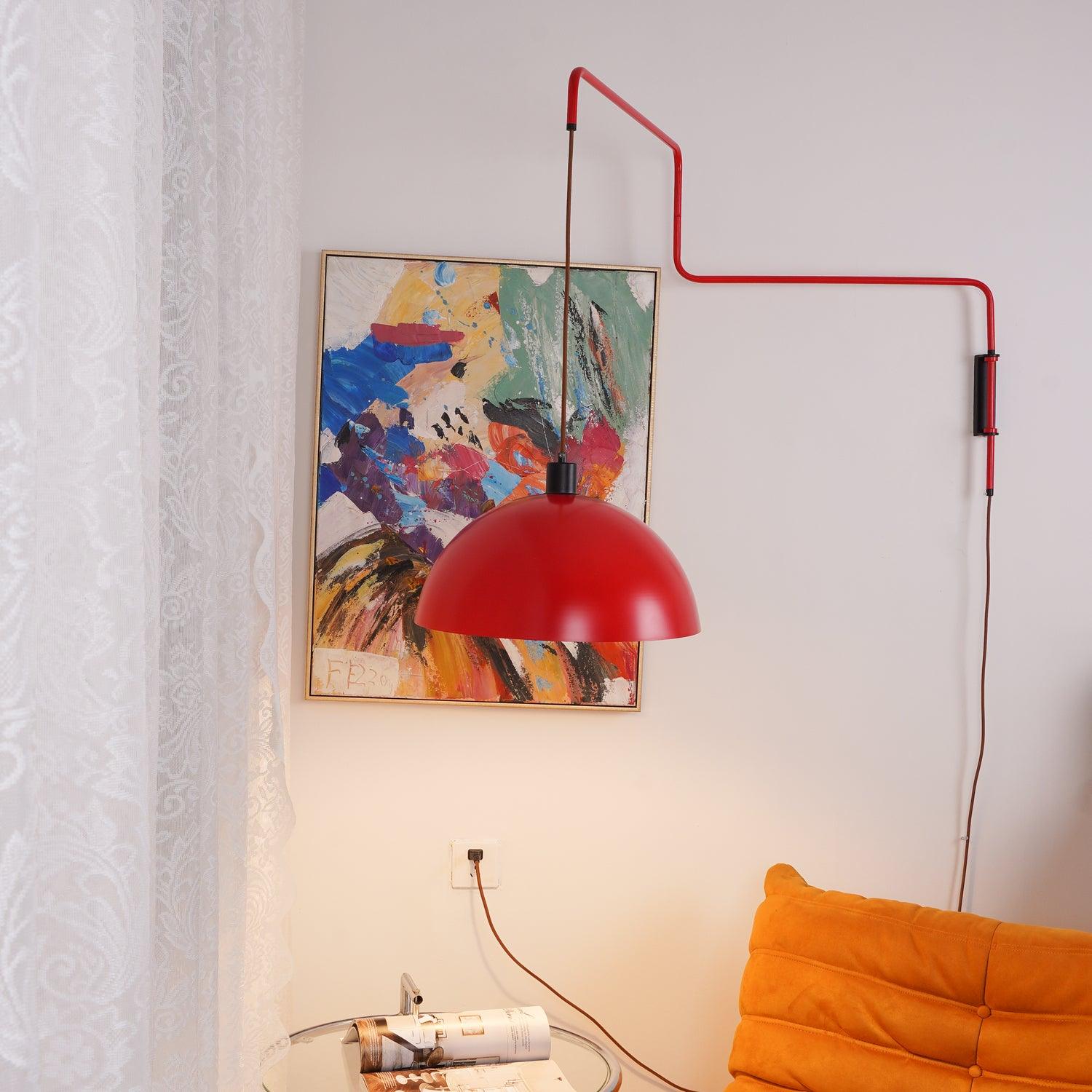 Suspended red shade near framed abstract art