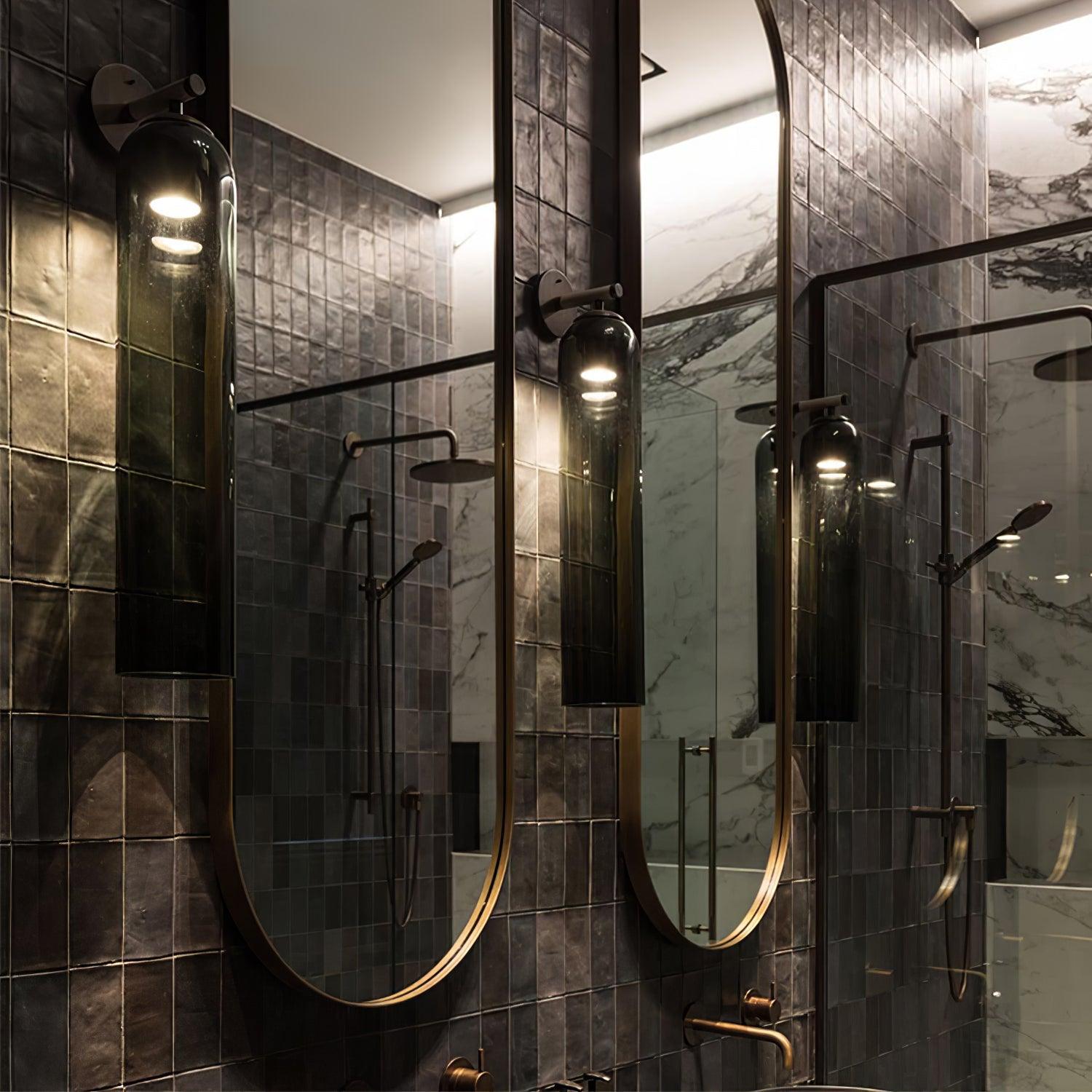 Glass sconces in a dark bathroom scene