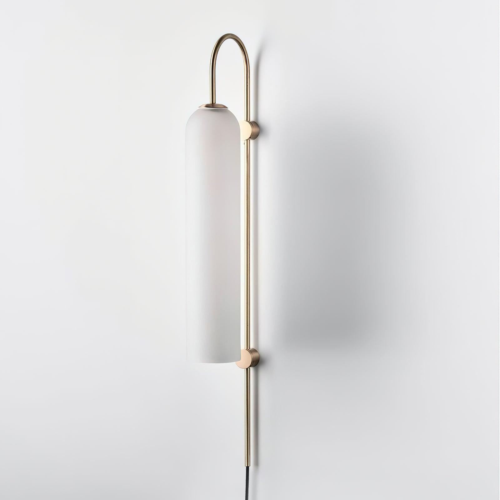 White tube shade on a gold-coloured wall frame