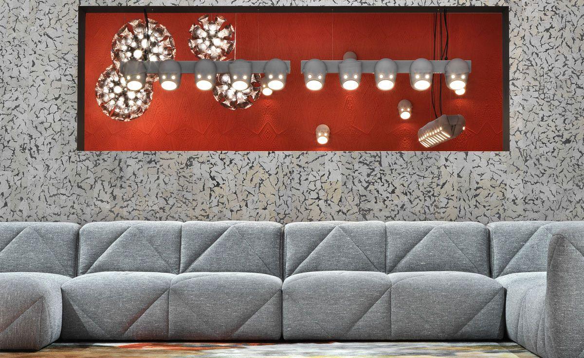 Face wall lights within a red wall feature above a sofa