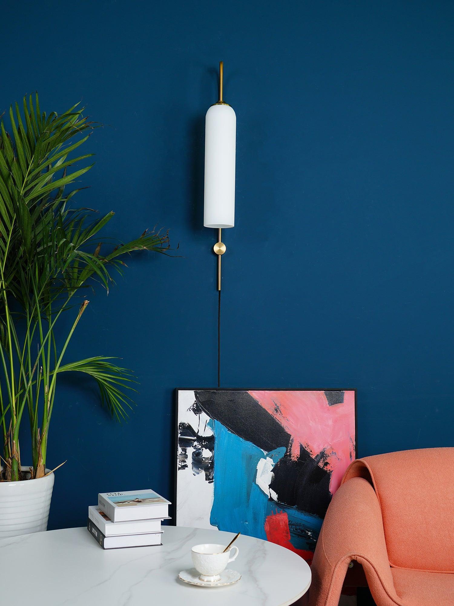 White tube lamp near an orange chair