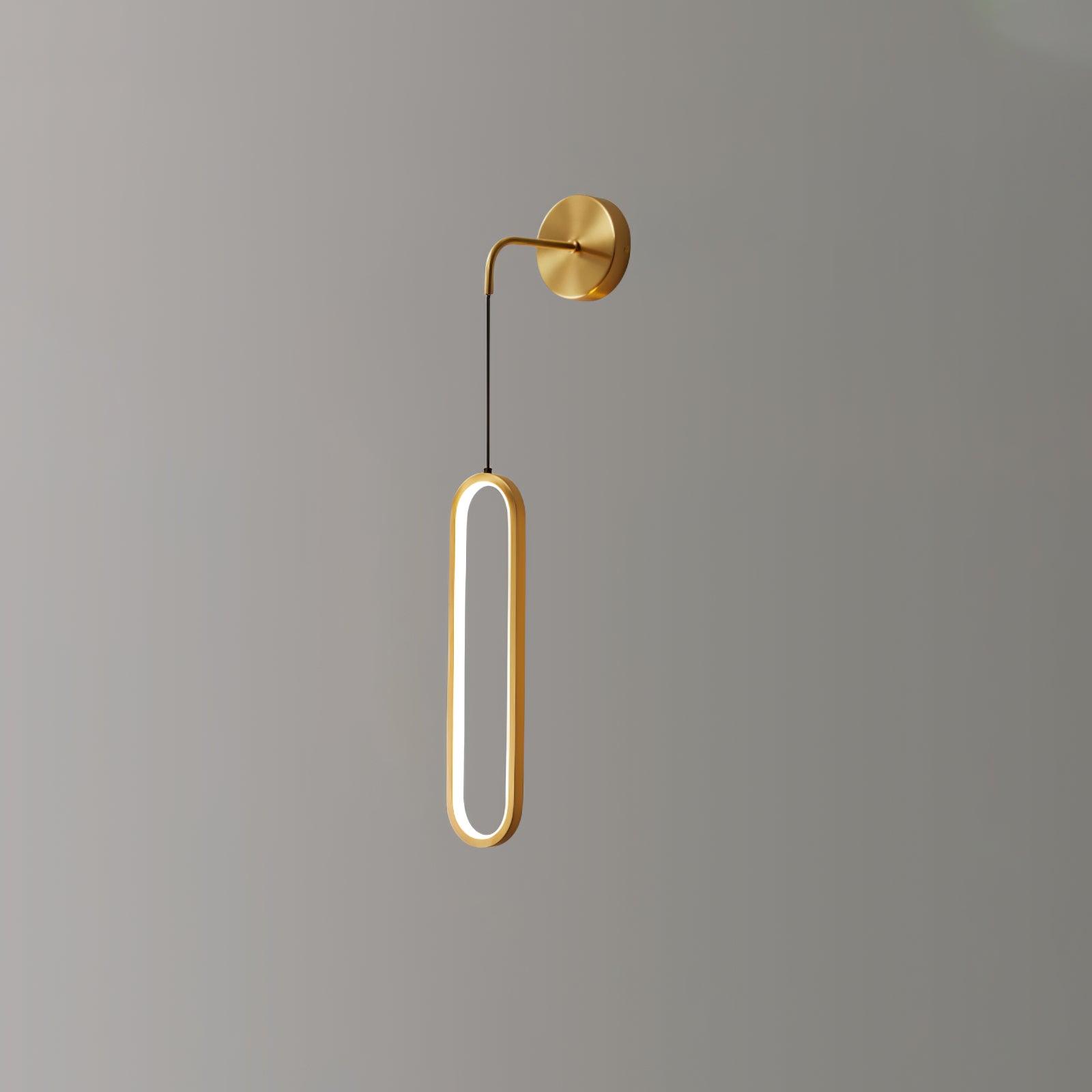 Brass suspended oval ring viewed at an angle