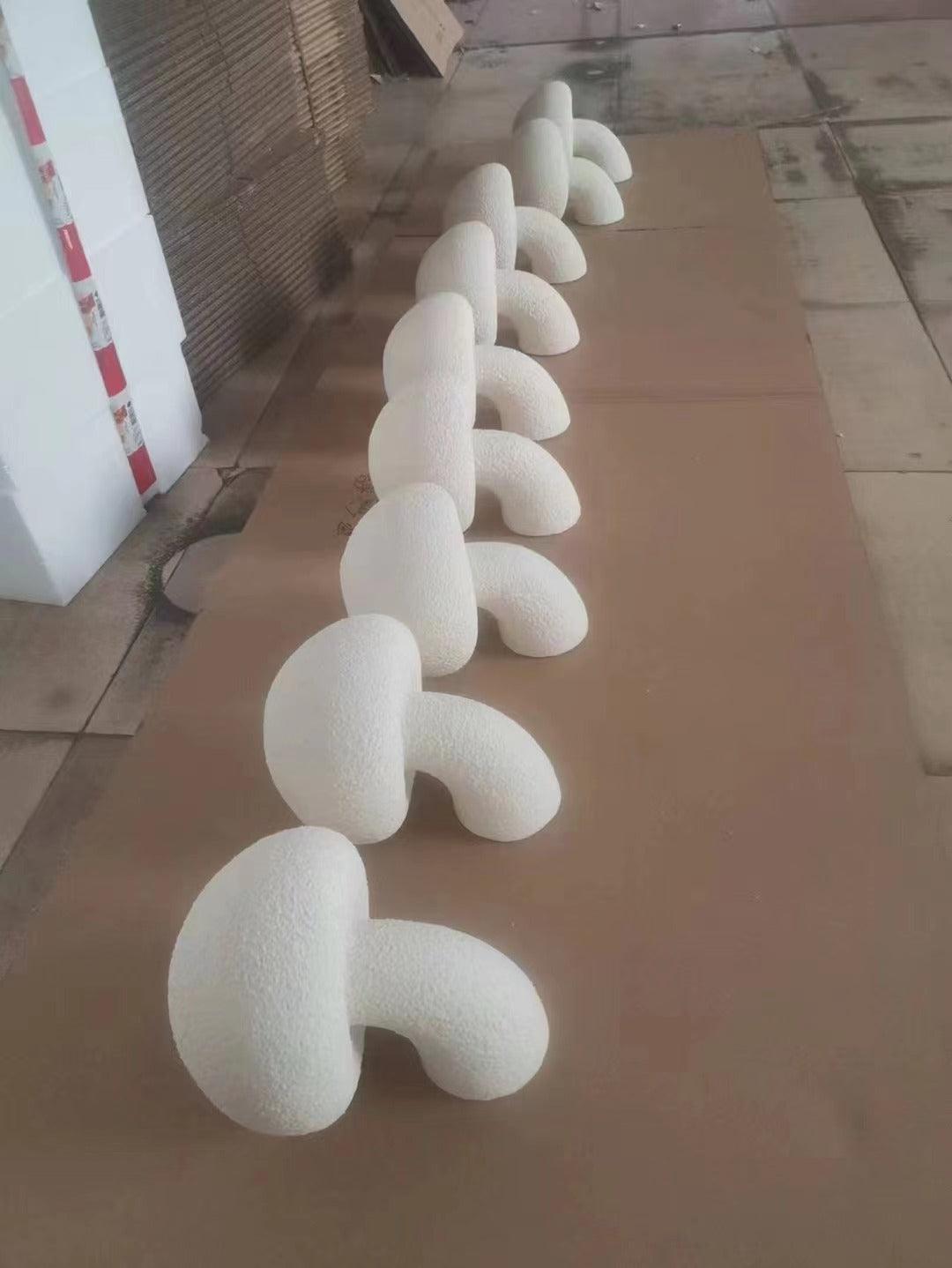Multiple White mushroom-shaped lamp bodies in a row