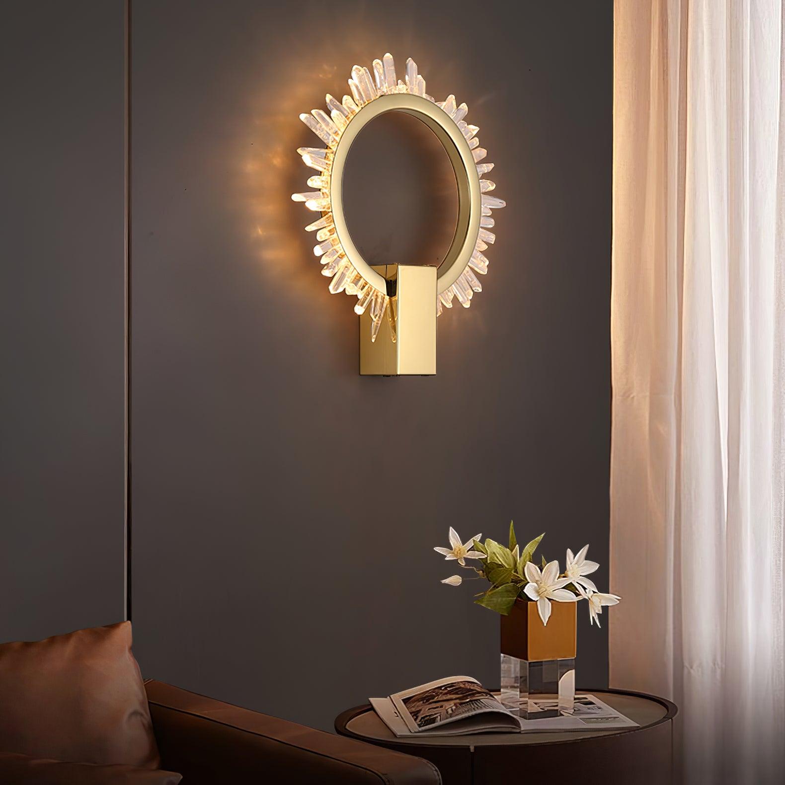 Angled crystal ring wall light above flowers and an open magazine beside a brown sofa
