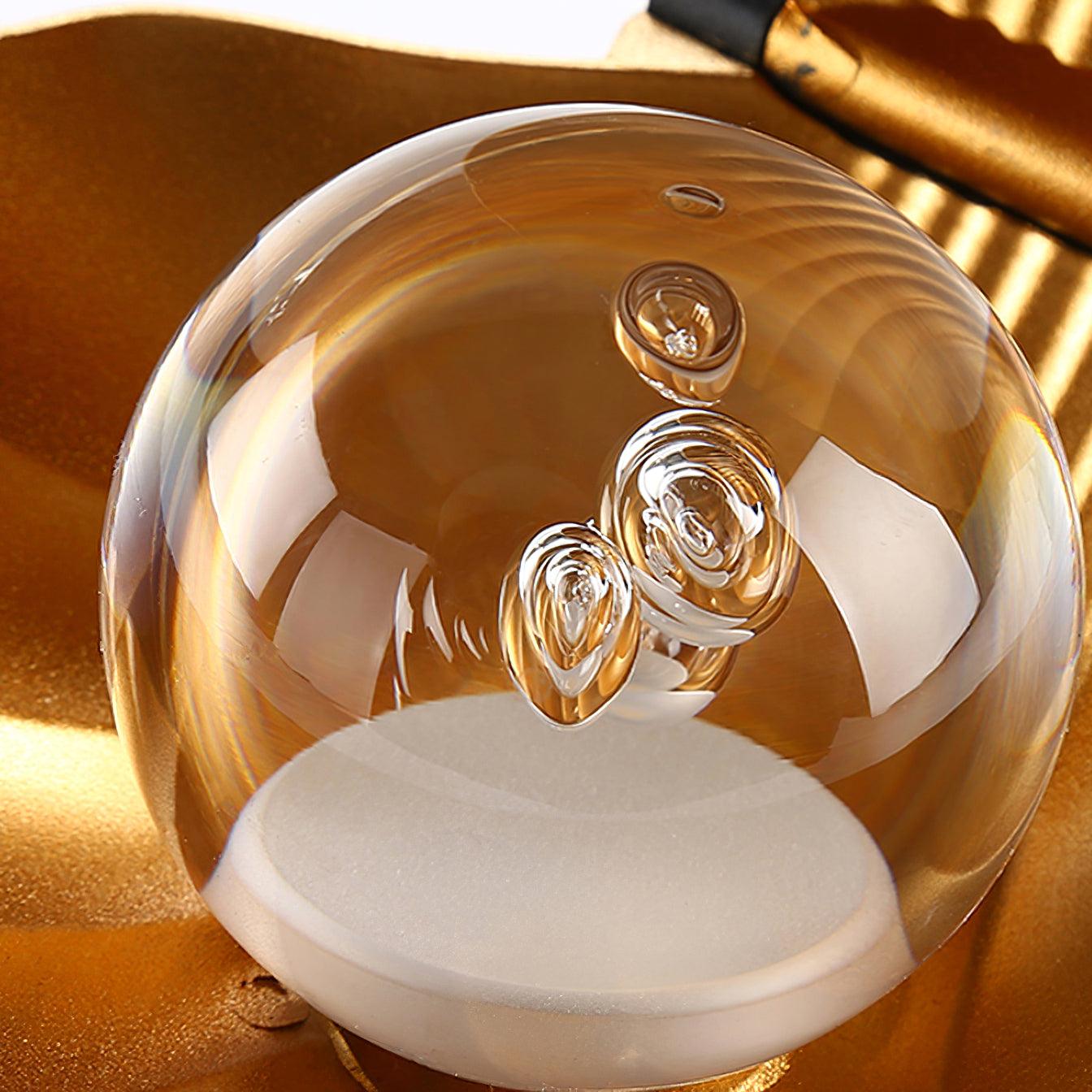 Close-up of the clear spherical element with bubble-like details above a white circular base