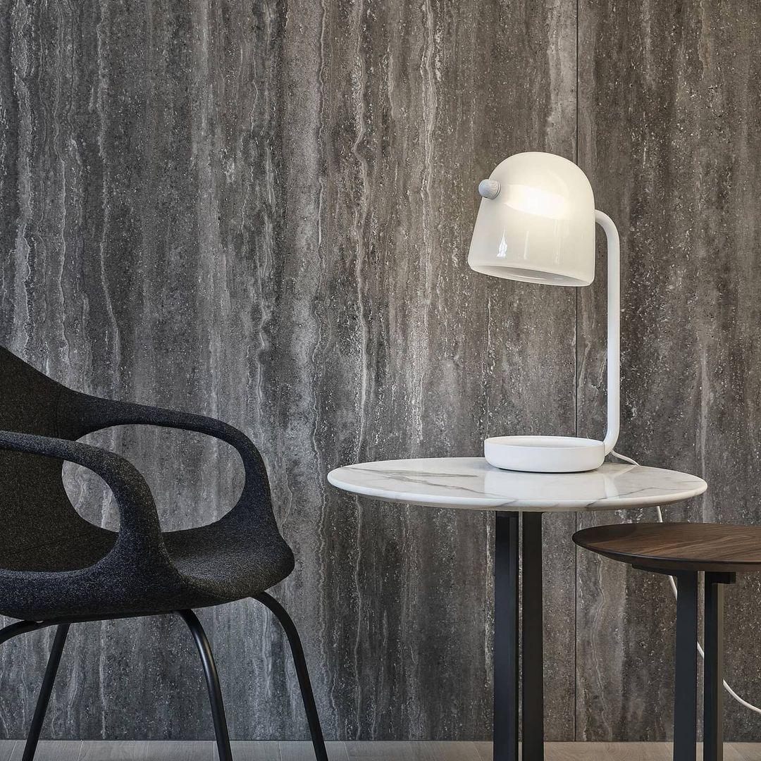 Mona White table lamp on a round side table near a dark chair