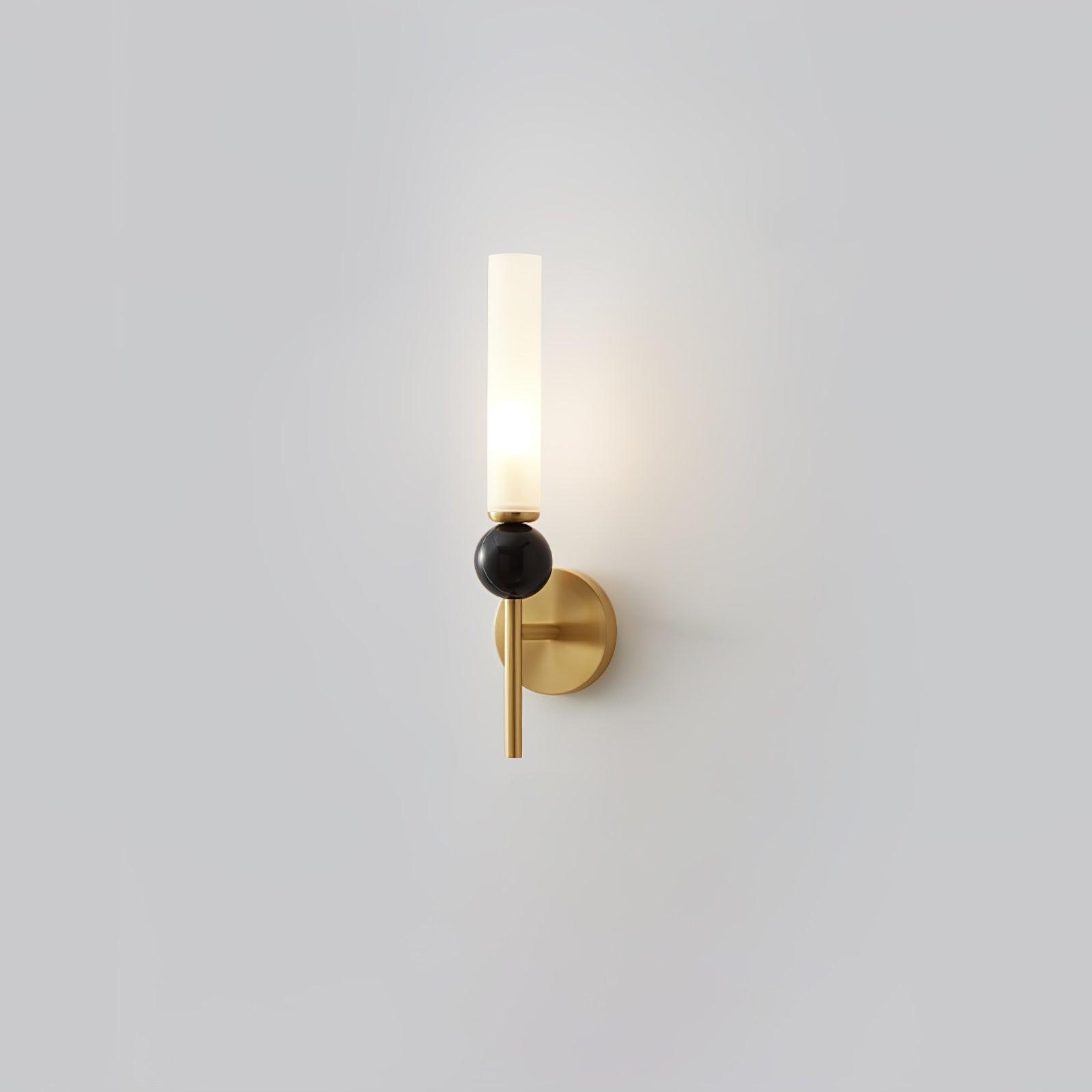 Alternate isolated view of brass straight-stem marble wall lamp with round plate and lit tall white cylinder