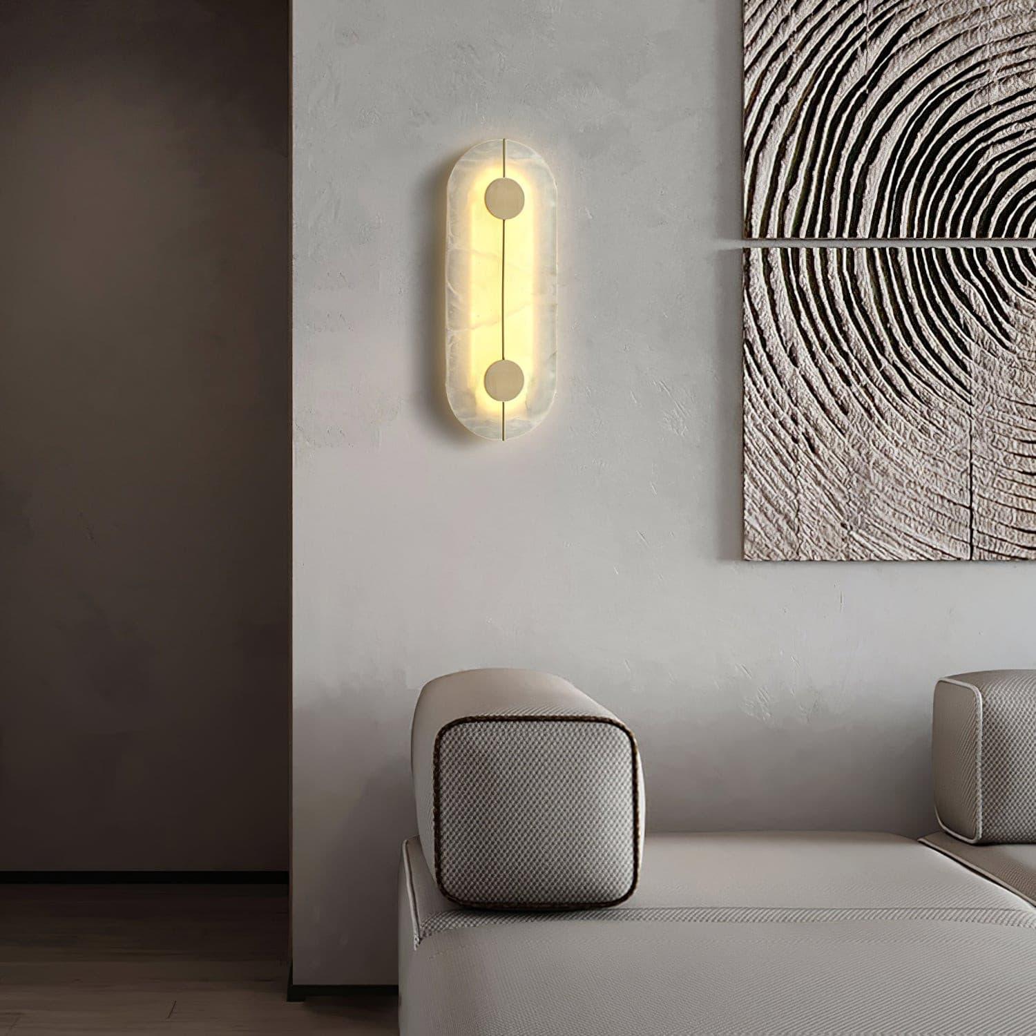 Tall capsule wall light beside lounge seating