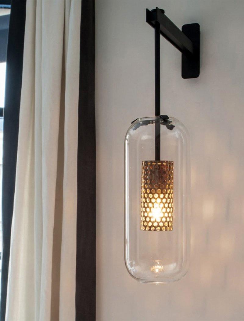 Black fixture and glass shade beside curtains