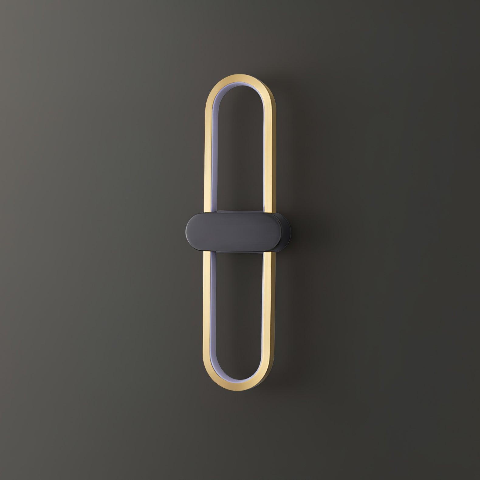 Unlit gold oval wall lamp with black centre and white inner strip on a grey background