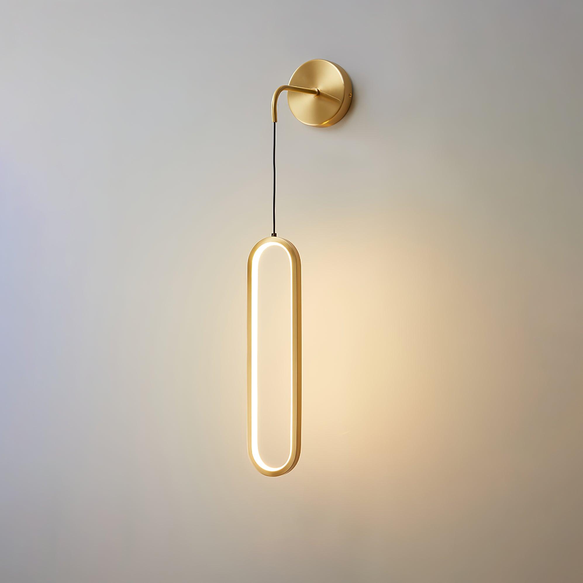 Brass oval light casting light on an interior wall