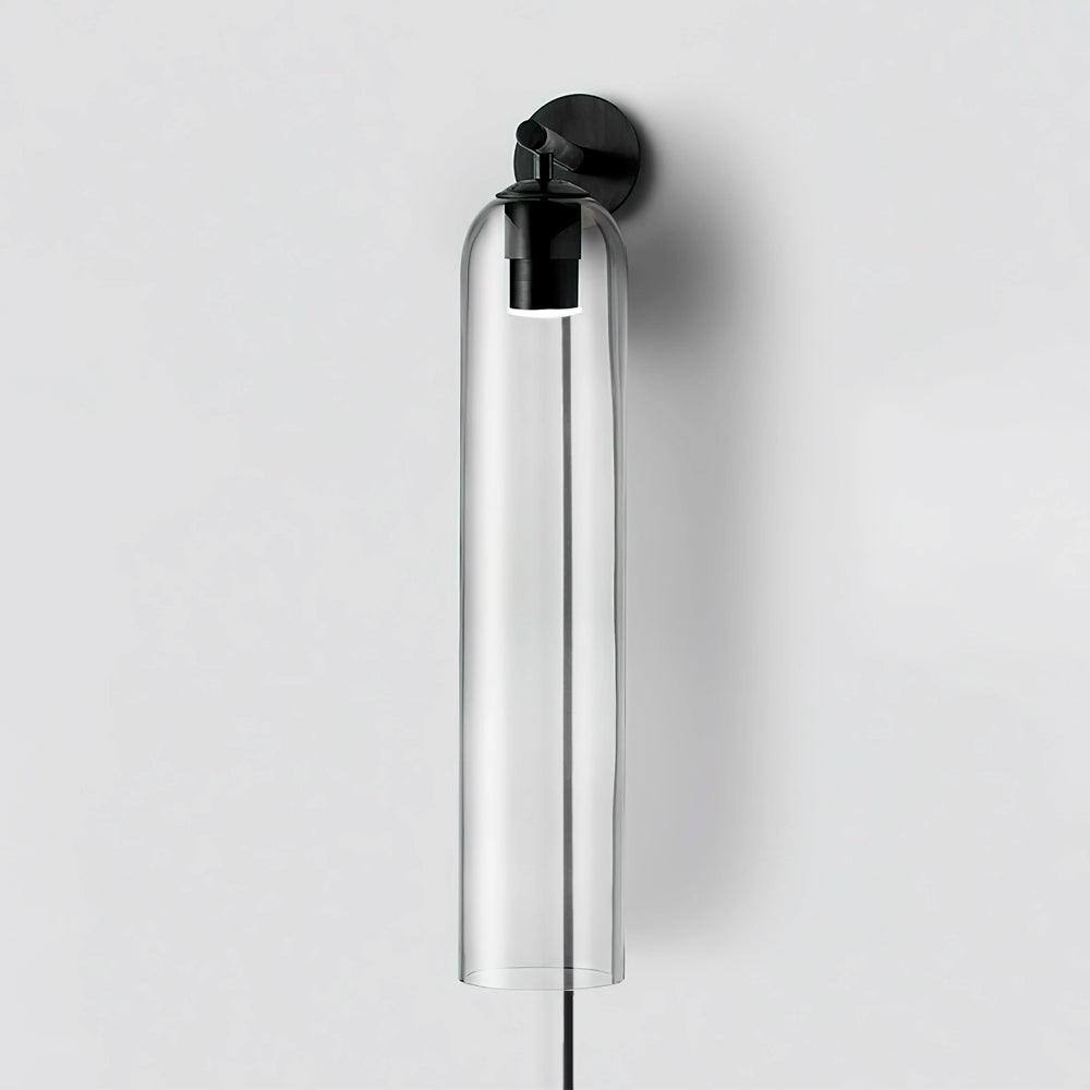 Clear glass cylinder with black wall plate and descending cord
