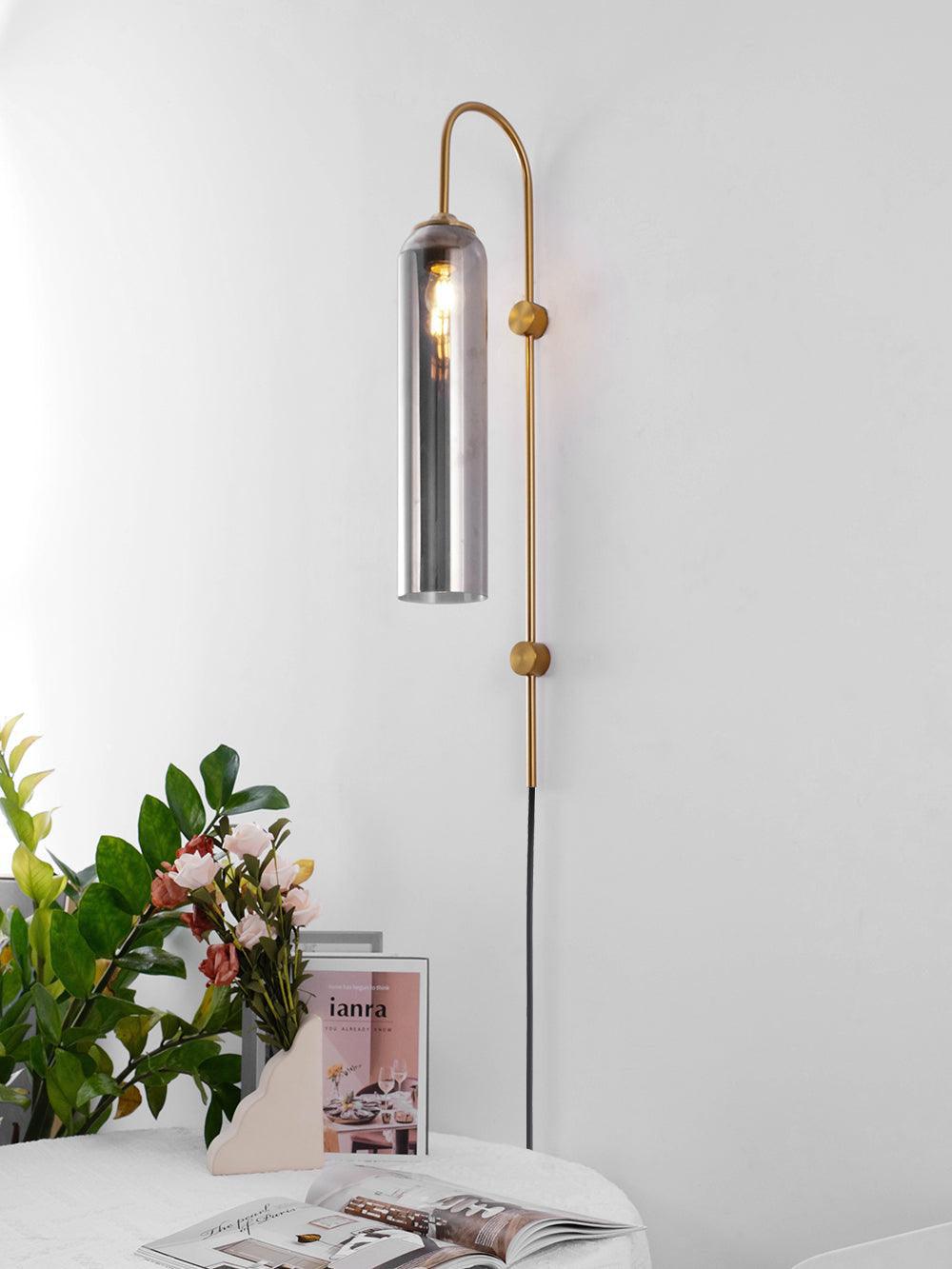Reflective glass tube with an arched metal arm