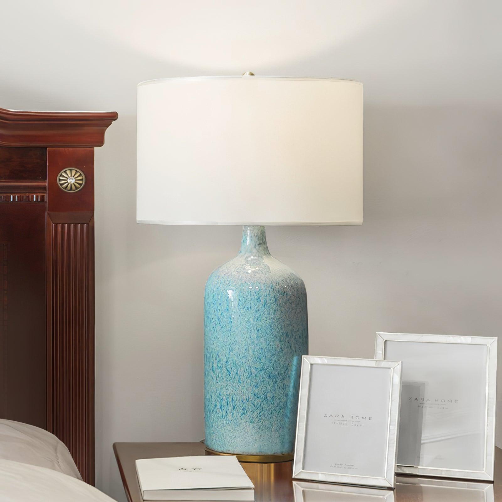 Culloden lamp on a table beside two picture frames