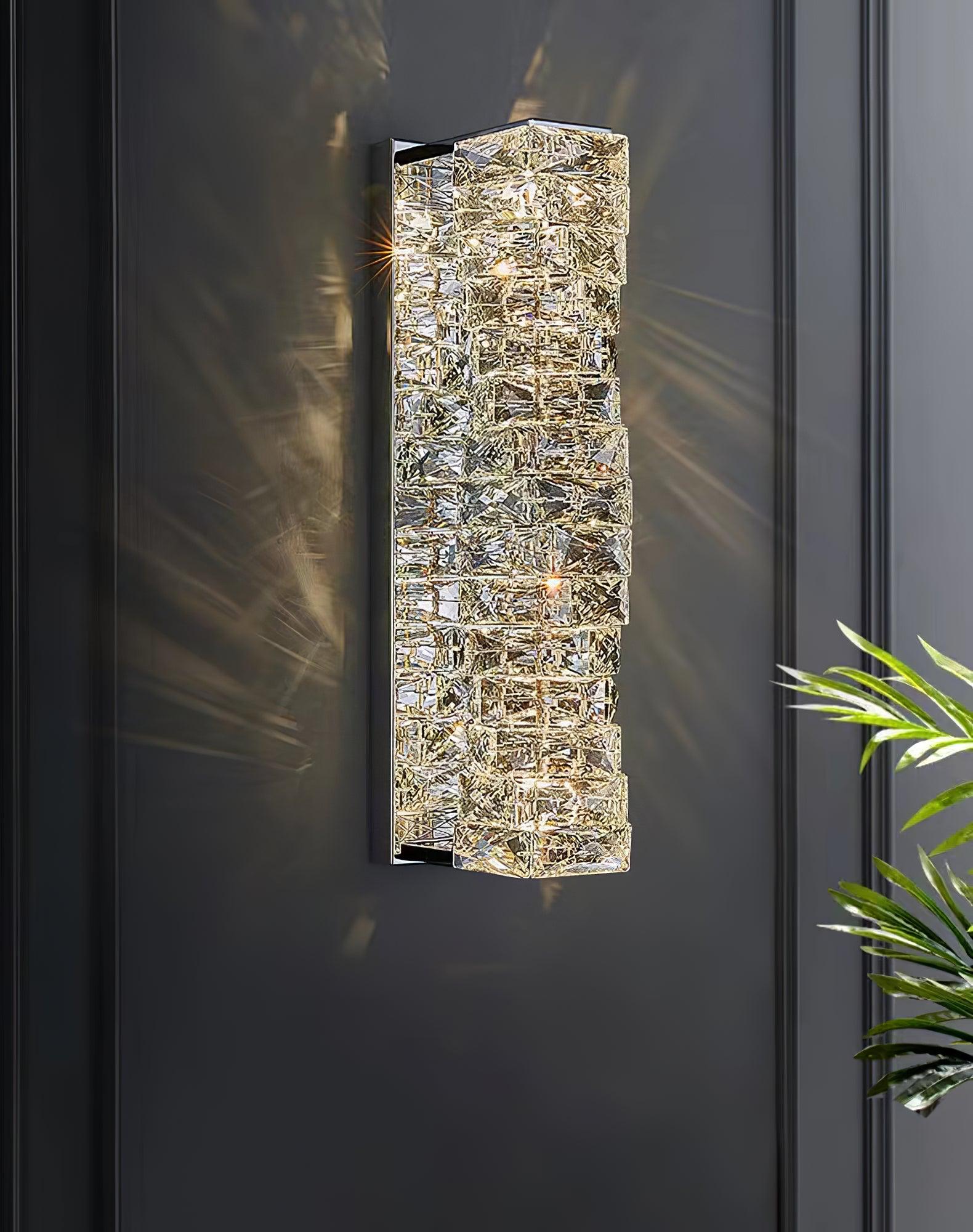 Chrome faceted wall light against dark panelling
