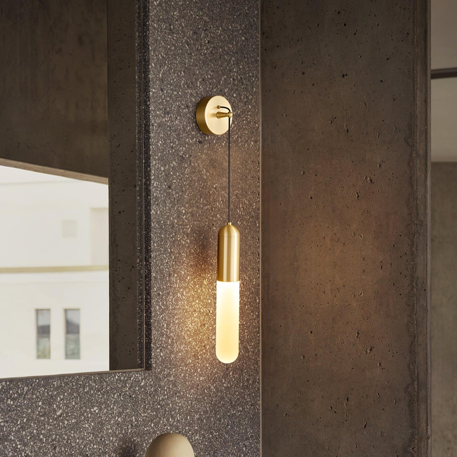 Brass capsule light beside a wash-area mirror