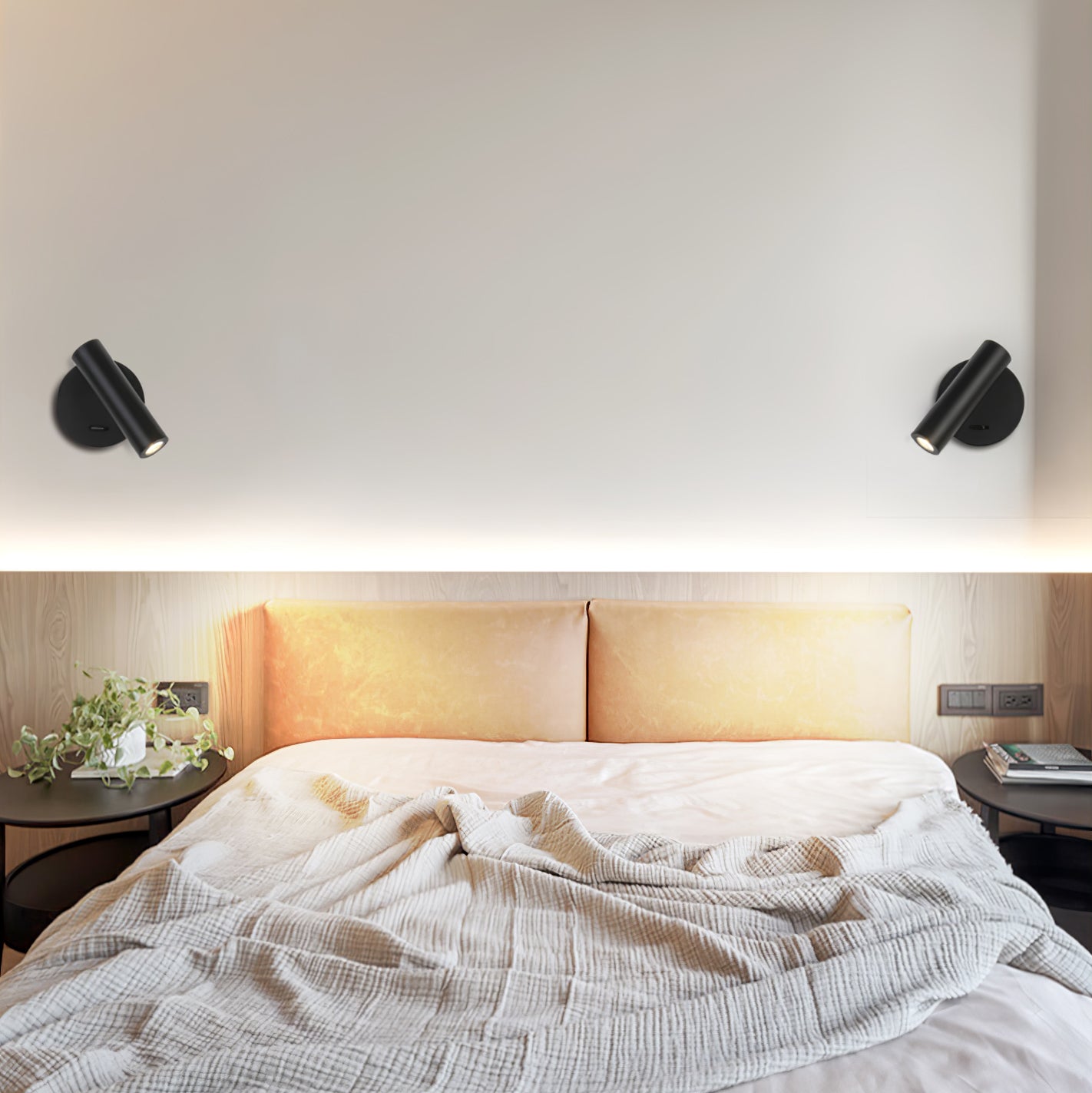 Two Black reading lights above a bed