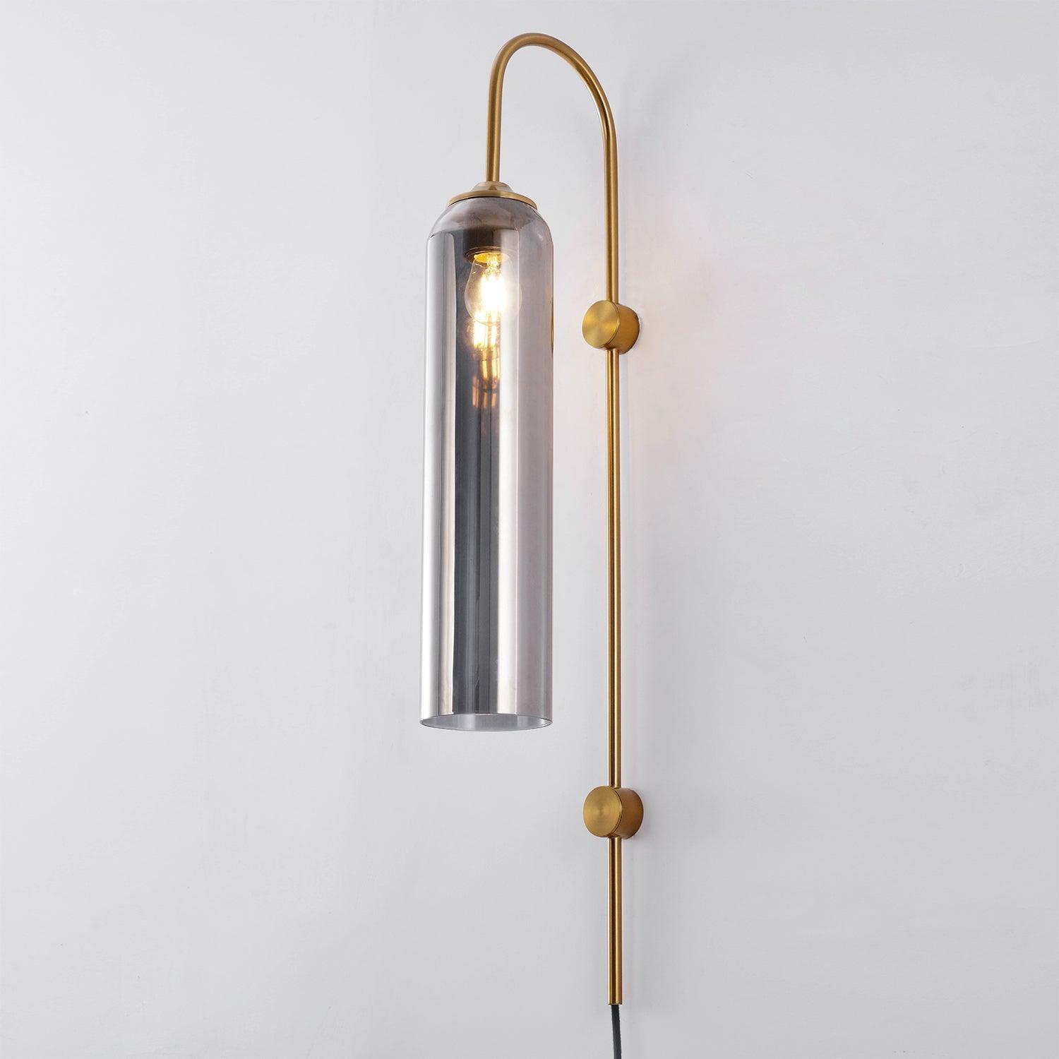 Reflective silver cylindrical shade on a gold-coloured wall stem