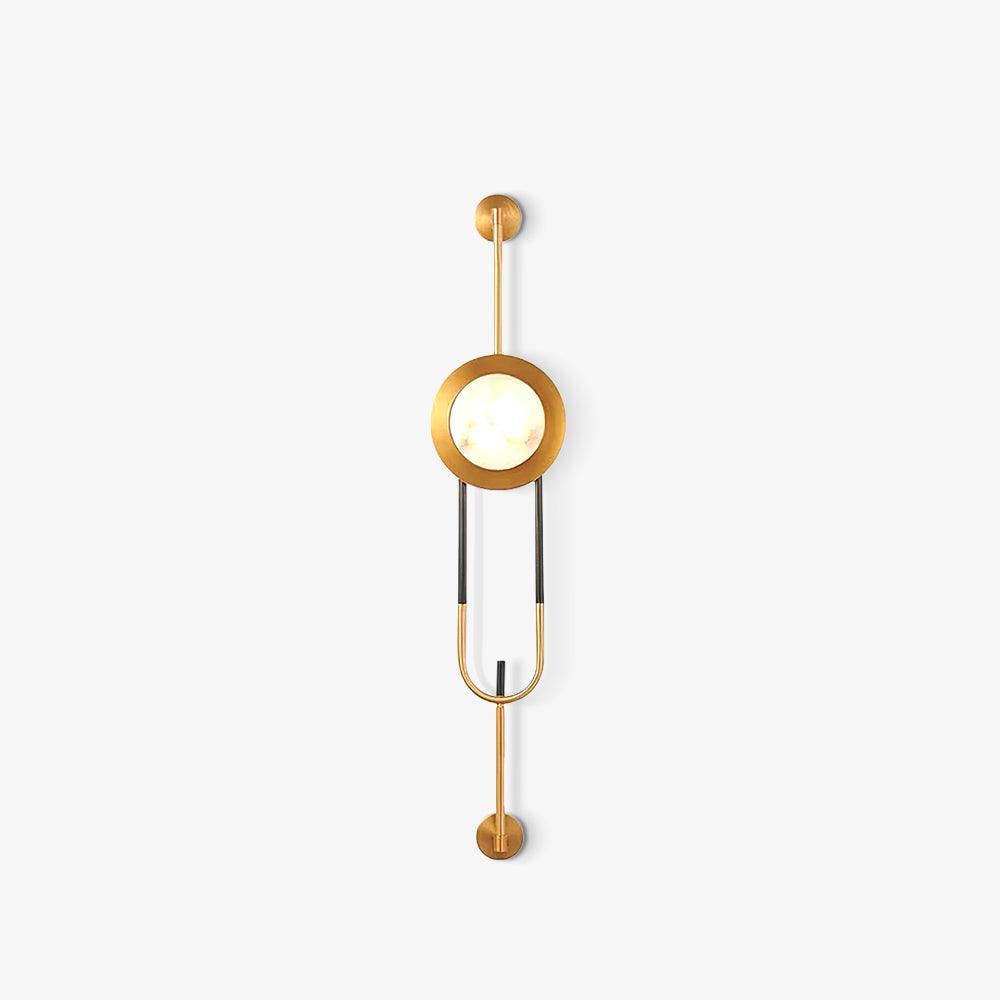 Small isolated view of the lit veined marble disc and elongated gold-and-black frame on white