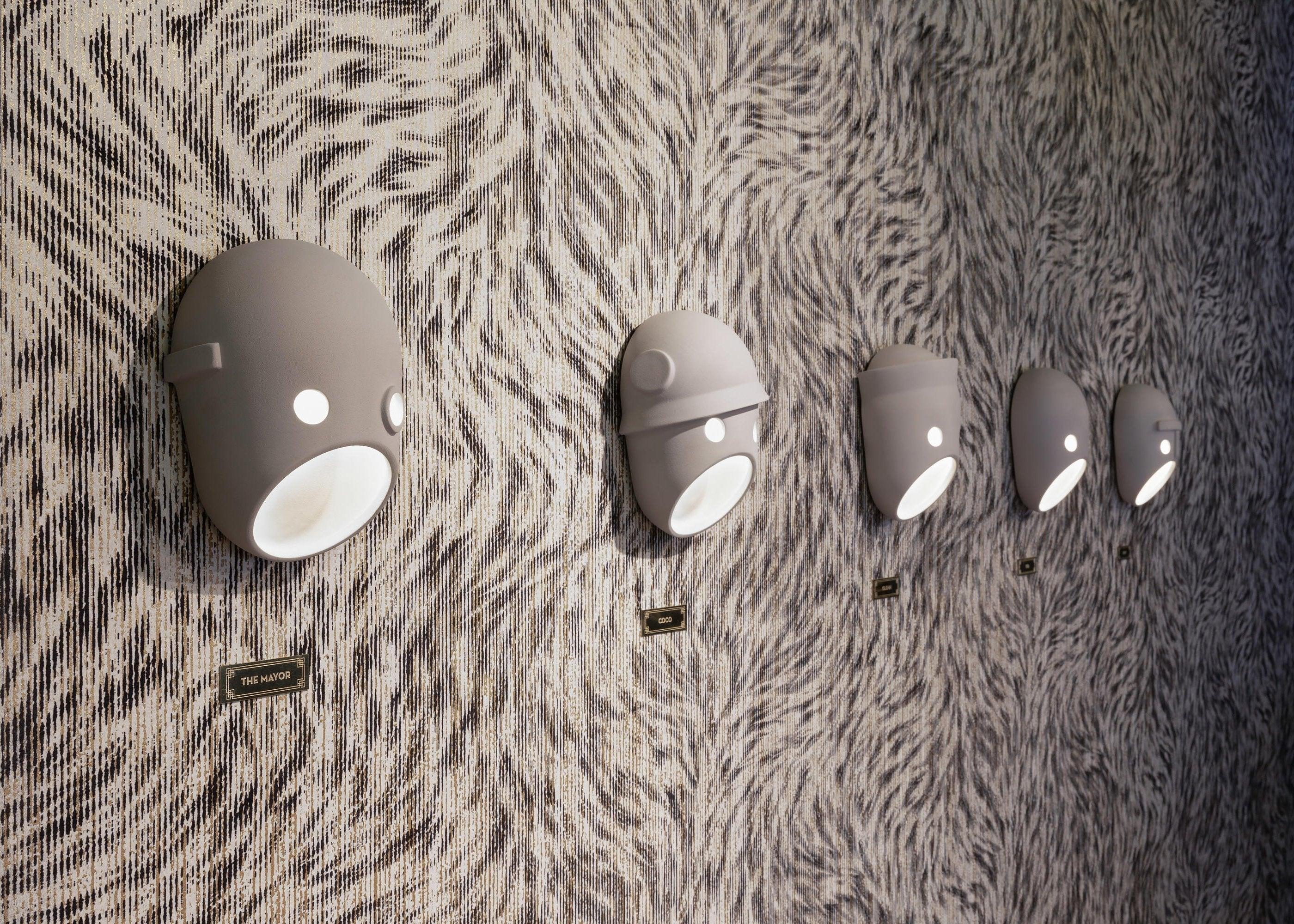 Face wall lights along a textured wall