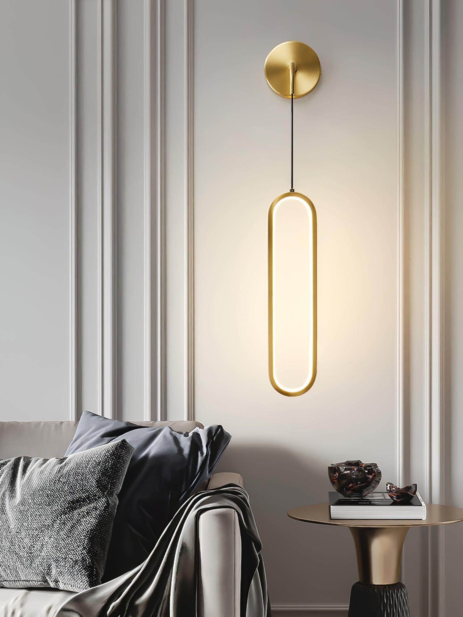 Brass oval light beside a seating area