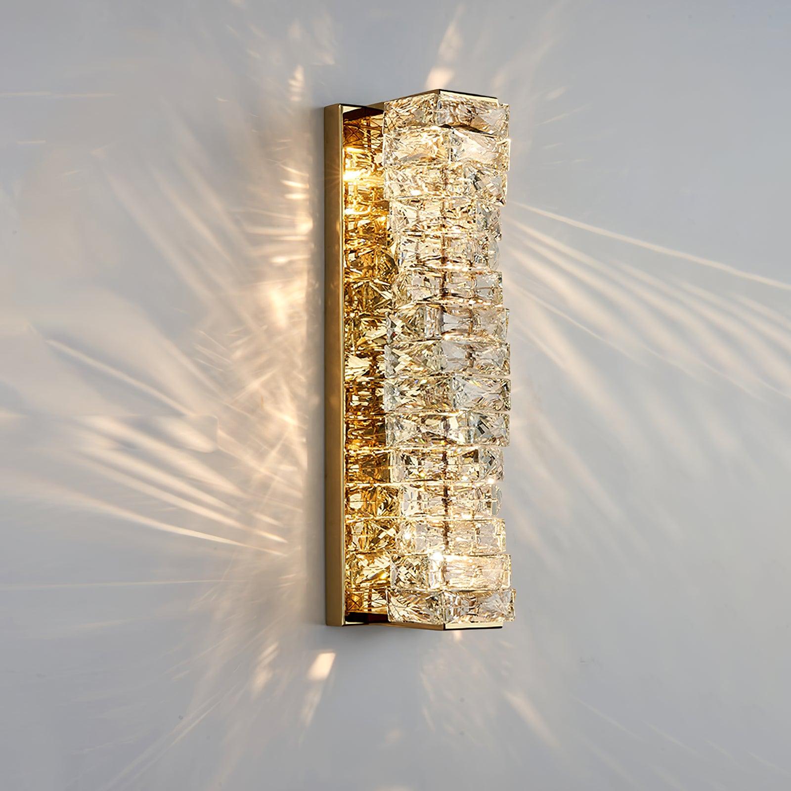 60 cm gold-finish wall light with stacked clear crystal facets and reflected wall patterns