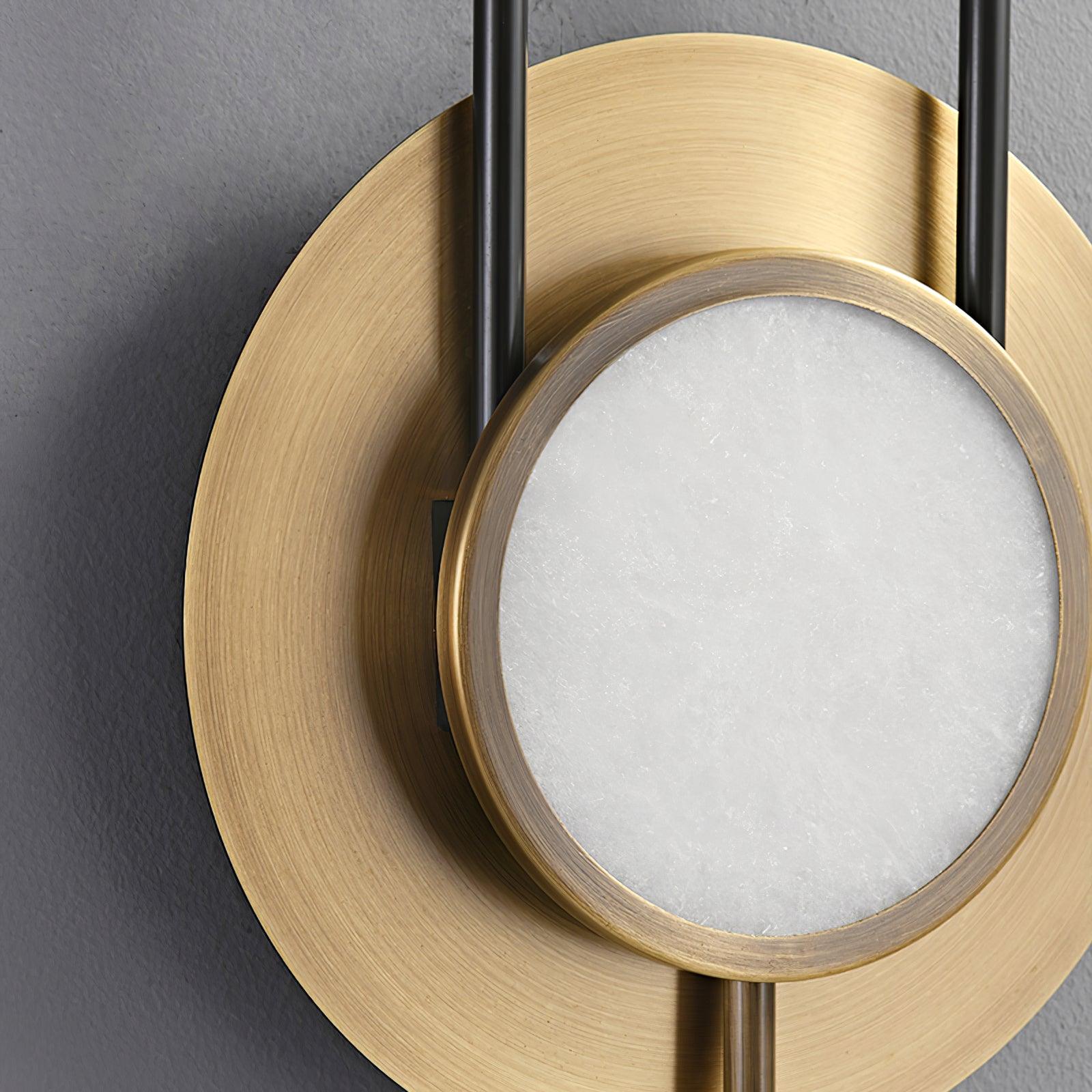 Close-up of the white marble face, gold rim and brushed gold outer disc with black frame sections