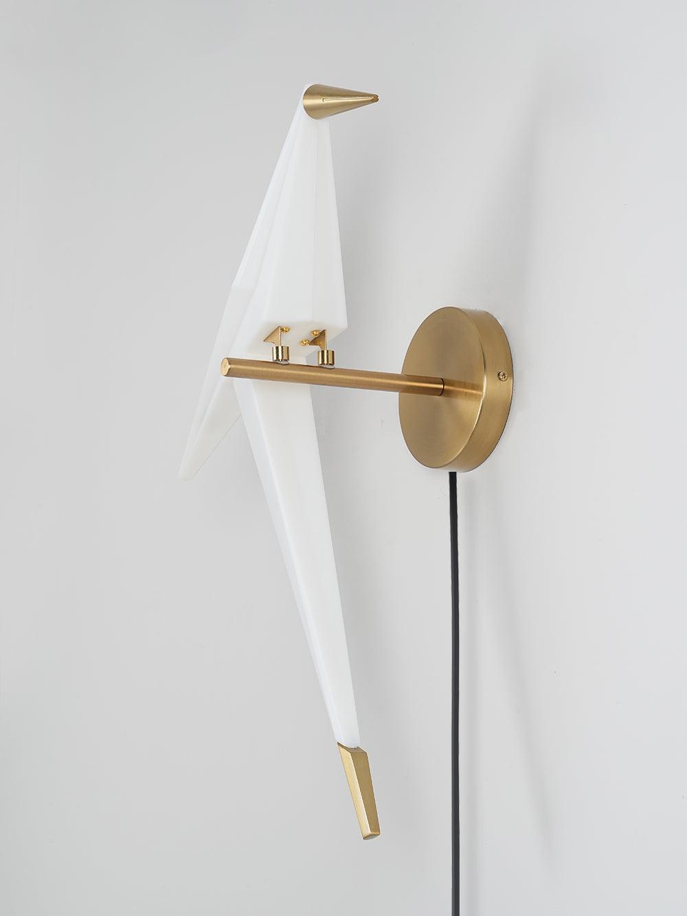 Unlit-looking White bird on a Gold arm and round wall plate, showing two small attachments, a side screw and Black cord