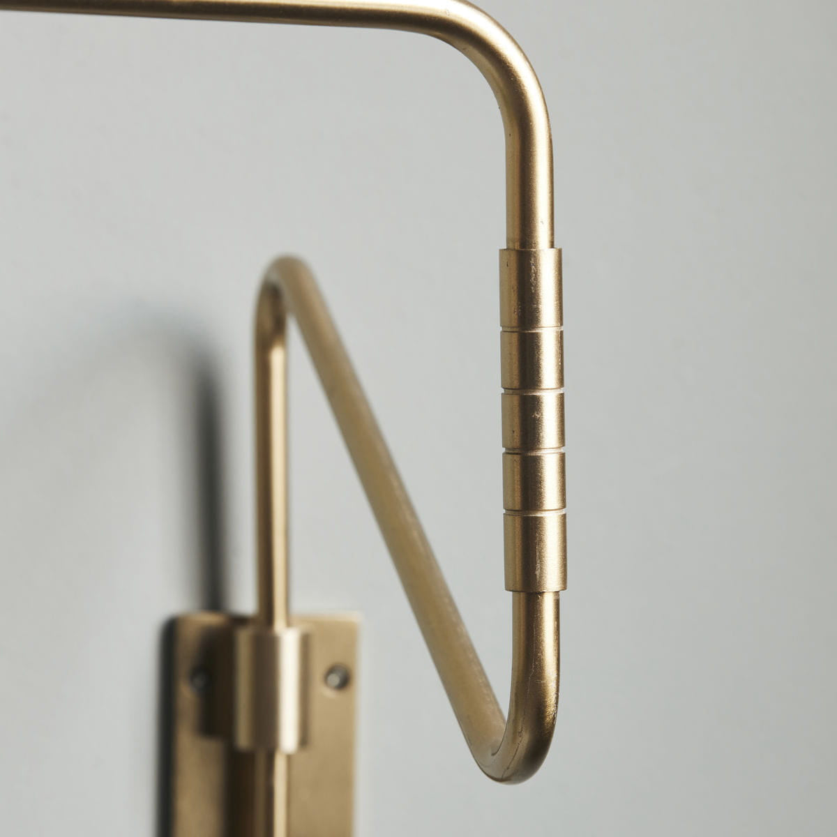 Close-up of Brass curved arm and cylindrical joint