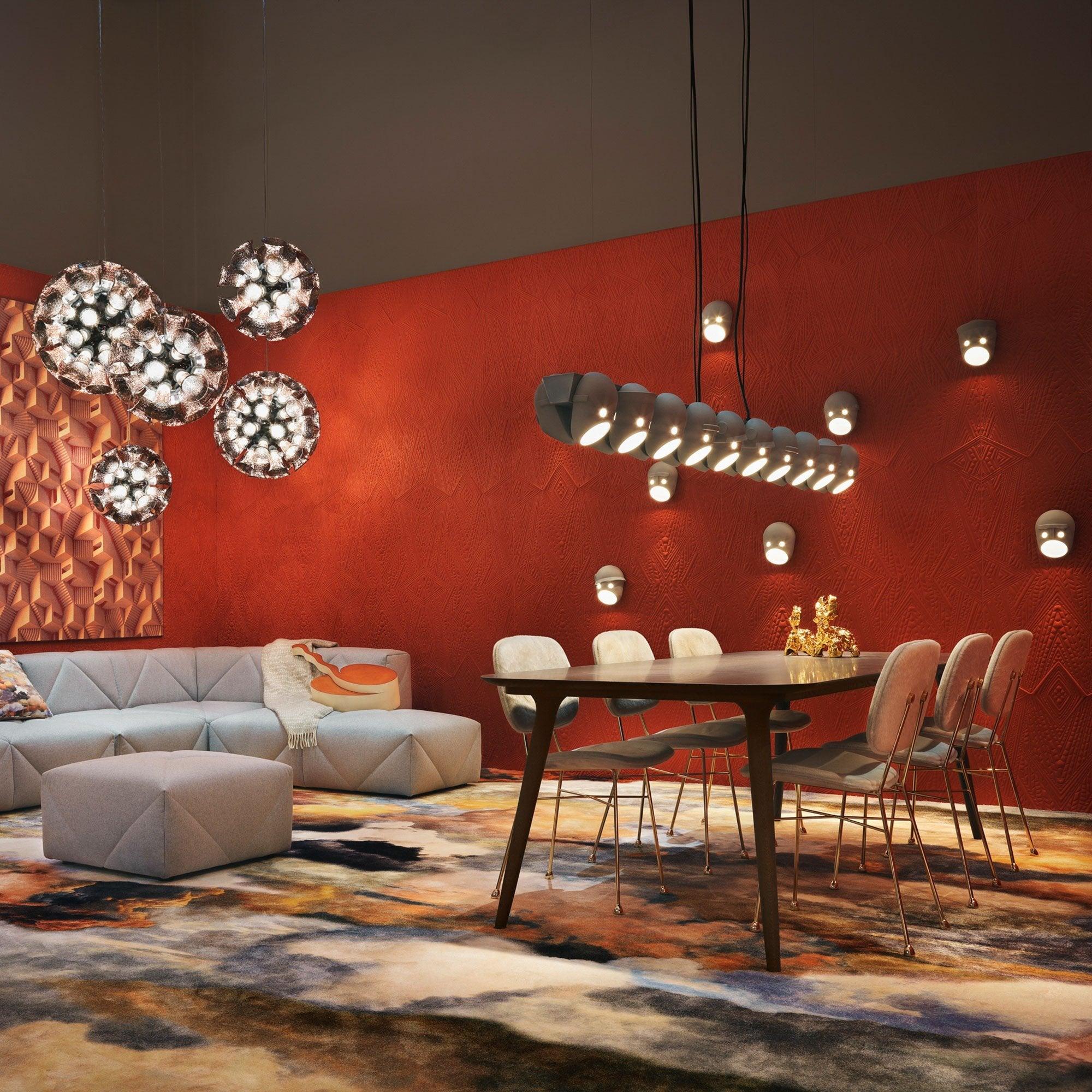 Face wall lights in a dining room with separate pendant lights