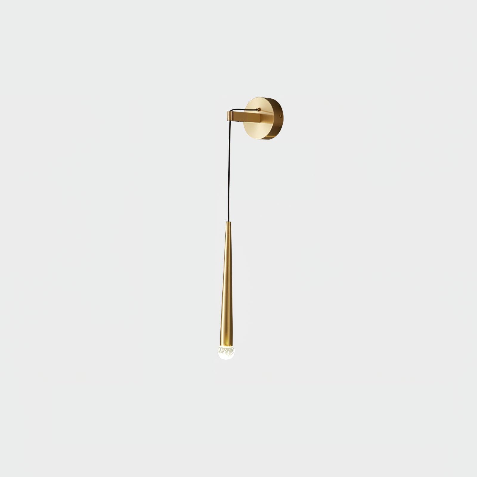 Small isolated brass-tone wall light with a rounded faceted tip below its tapered body