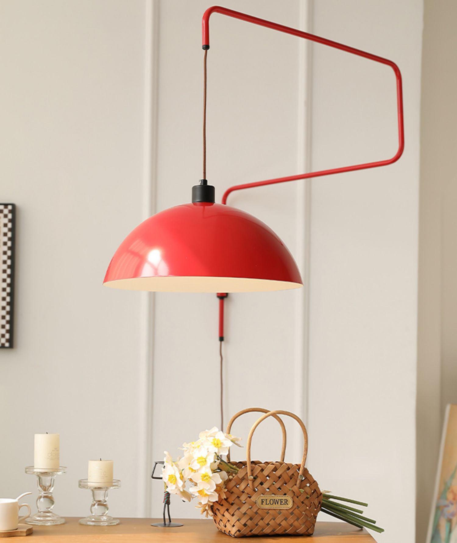 Red Elio wall lamp above a flower display
