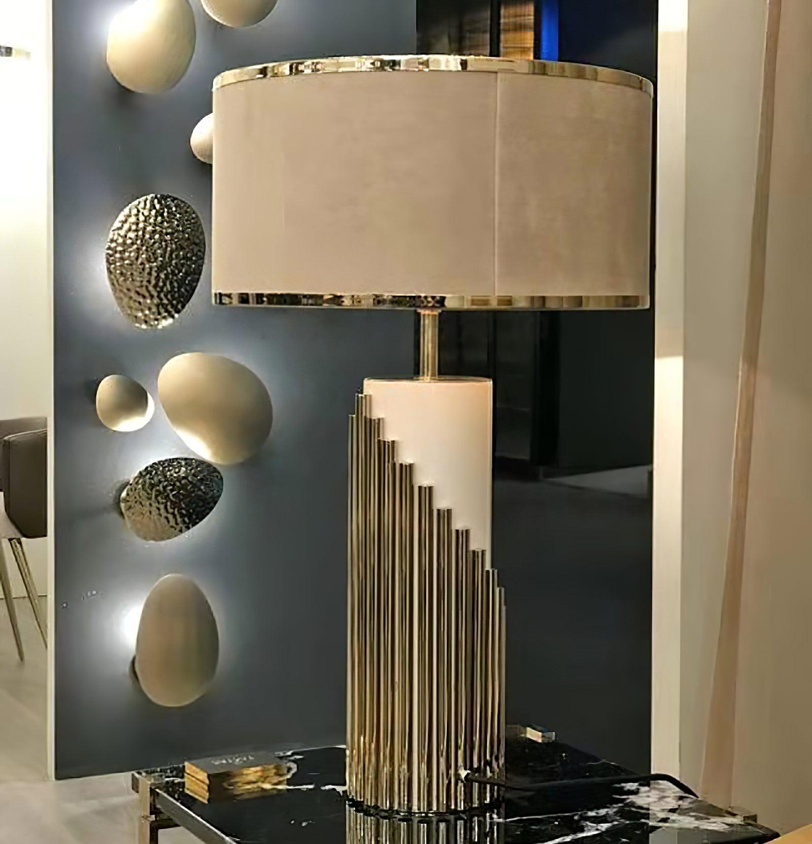 Streamline lamp on a dark glossy console near circular wall art