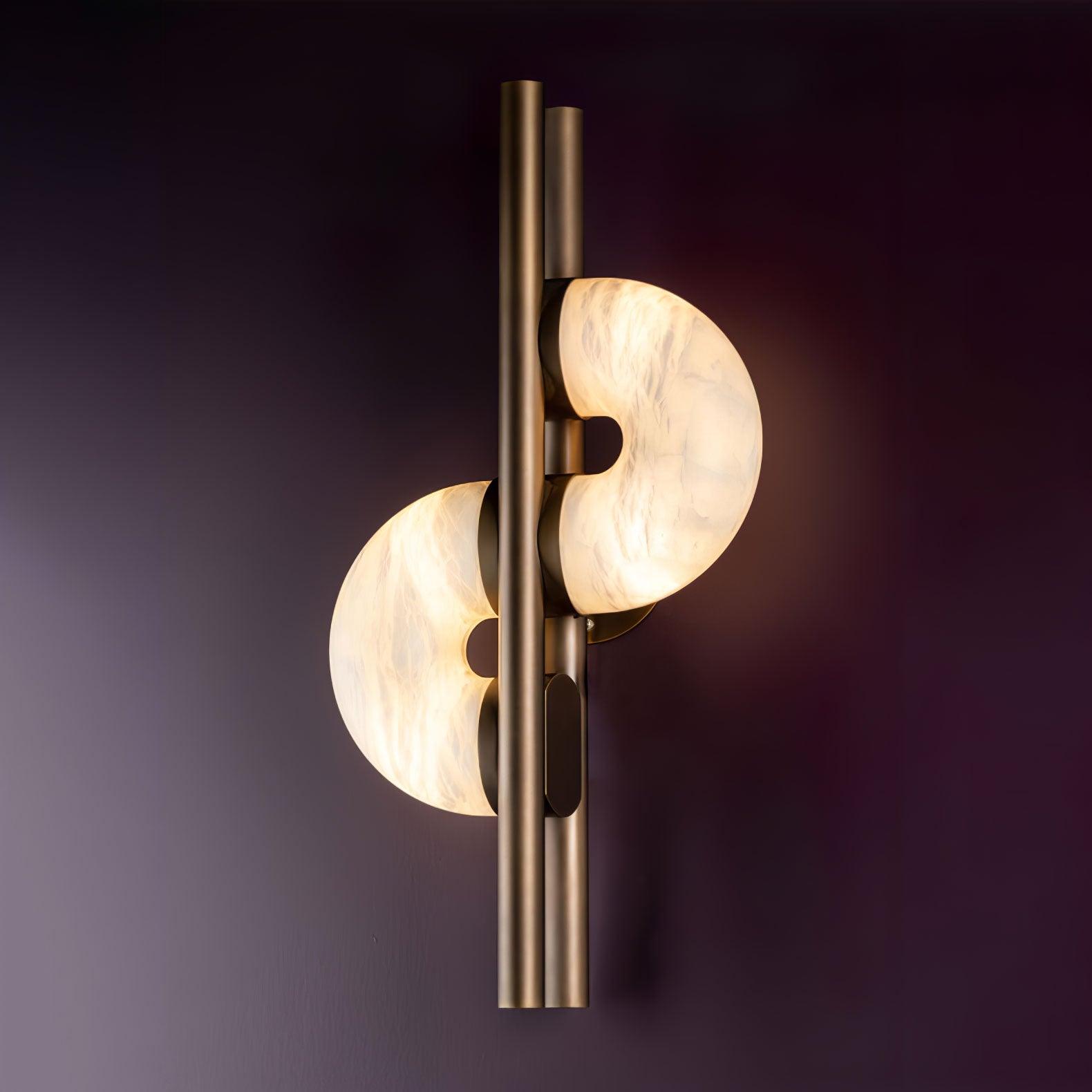 Lit oblique Dolly on purple wall, showing staggered stone discs, parallel bronze tubes, attachment caps and round rear mount